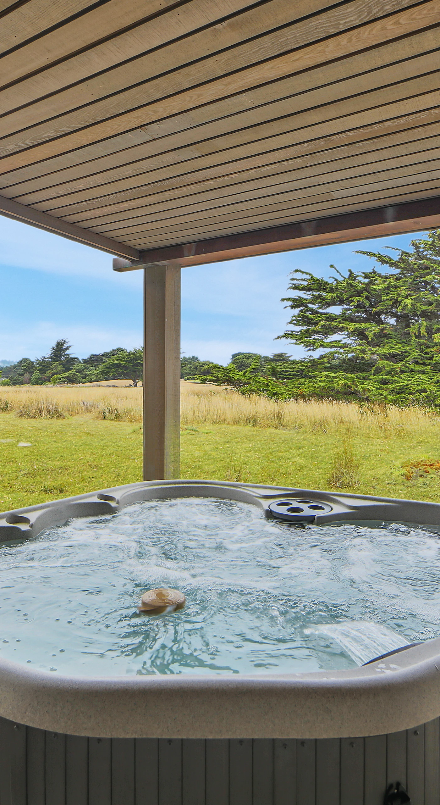 Soak in your private hot tub and let the gentle breeze carry your worries away as you unwind in this peaceful retreat.