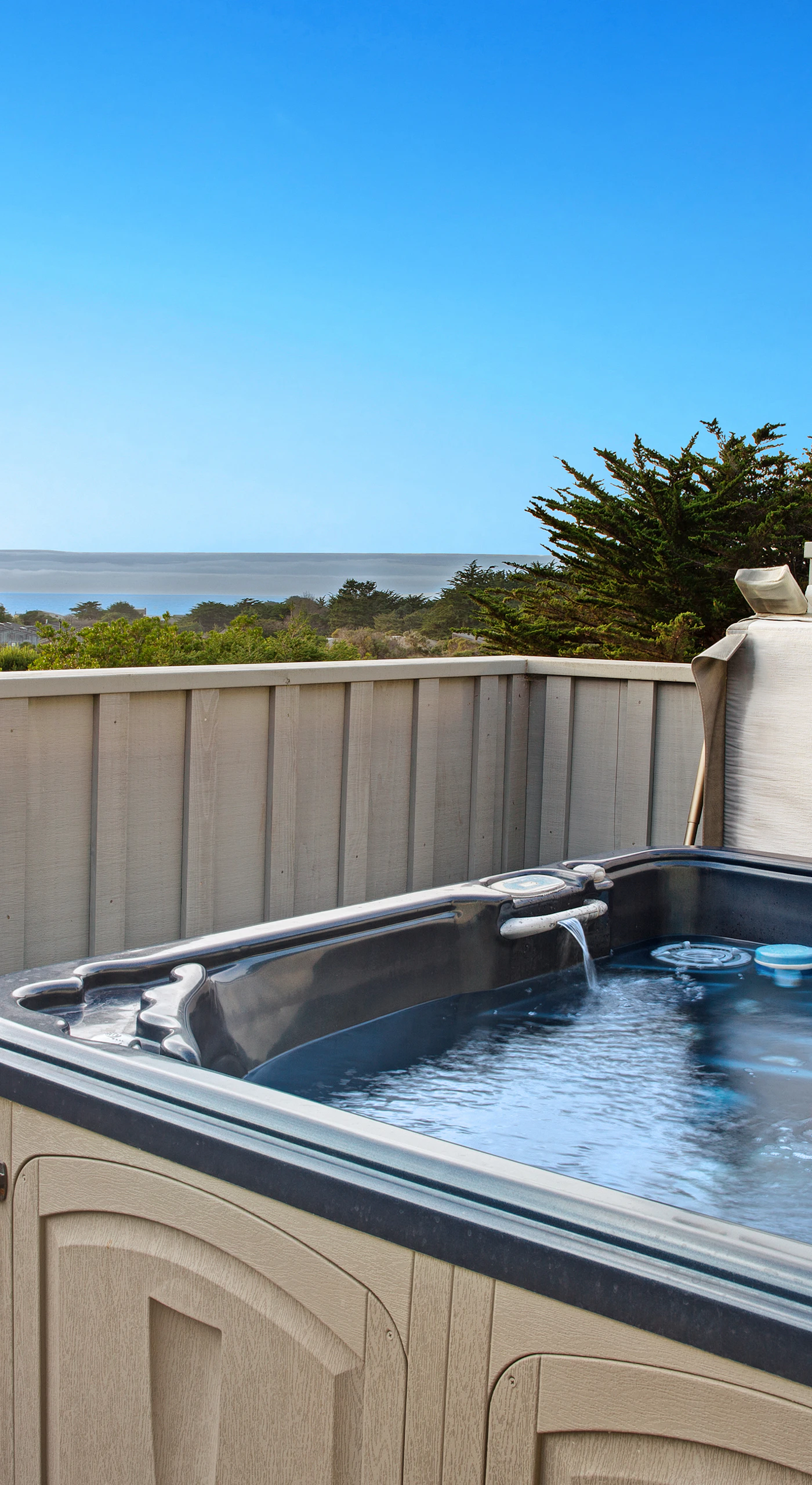 Soak in the bubbles and ocean views from the hot tub, the perfect way to unwind after a day of coastal adventures.