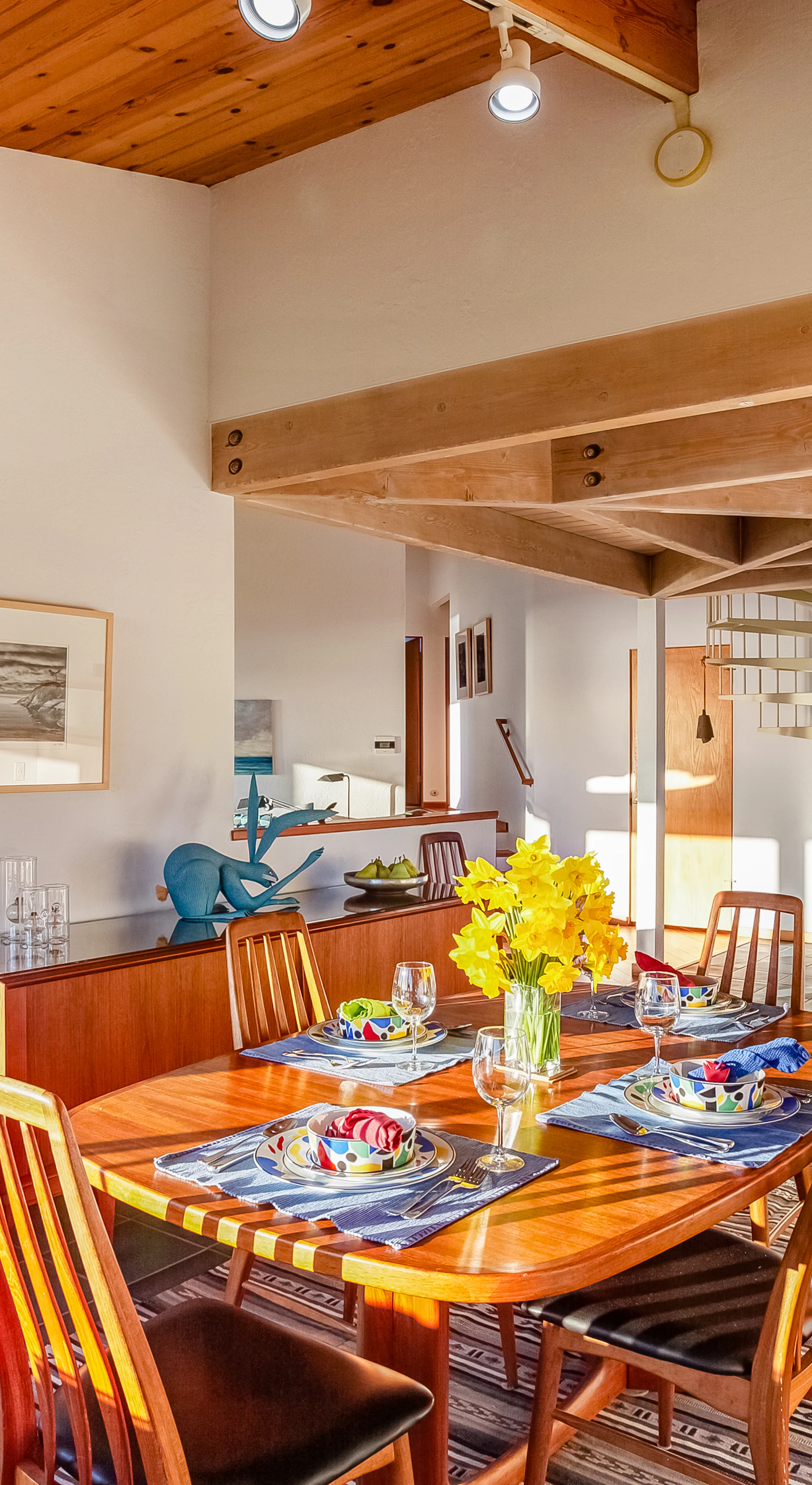 Set the table for a delightful meal in the dining area, where the soft glow of natural light enhances your dining experience with family and friends.