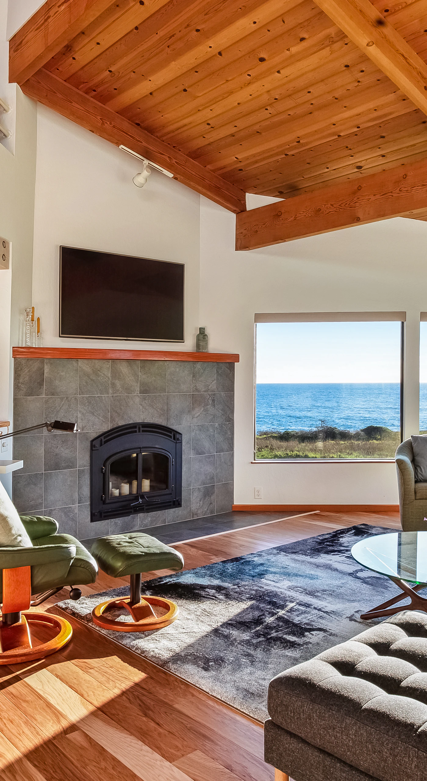 In the spacious living room, morning light dances across the ocean view, setting the perfect scene for cozy gatherings with loved ones.