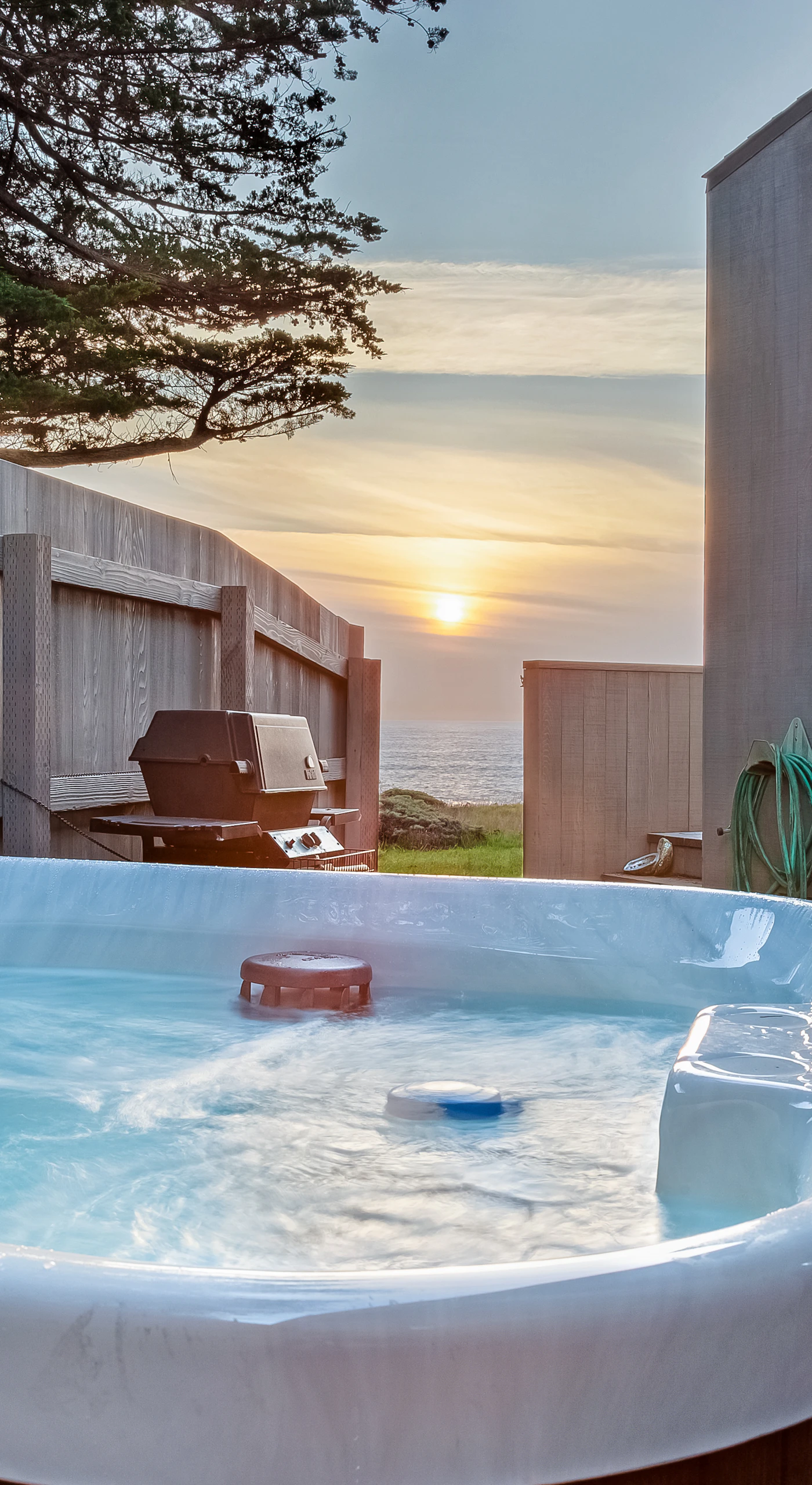 Imagine soaking in your private hot tub, sipping a drink while the sun dips below the ocean horizon, creating a perfect end to your day.
