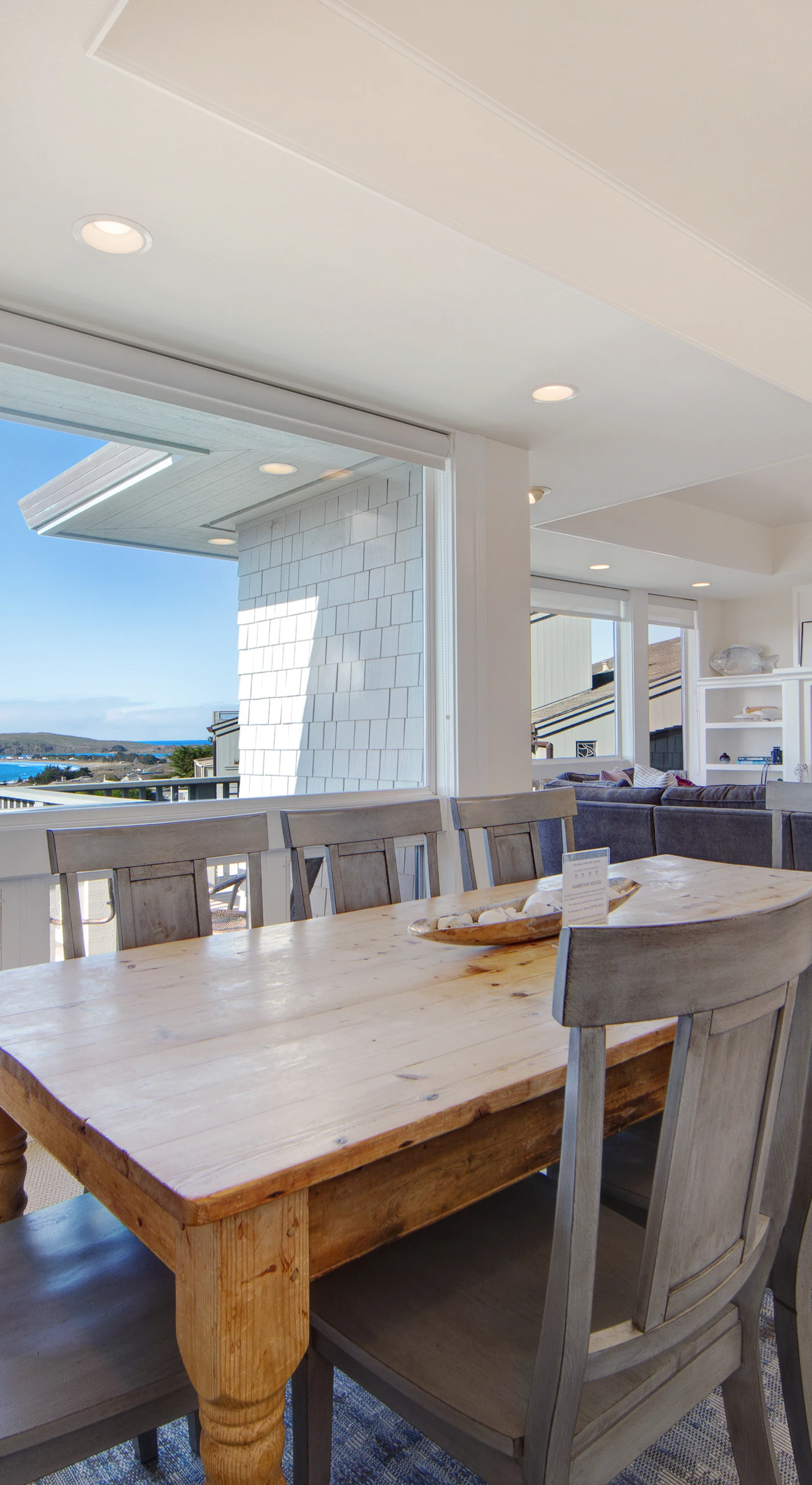Share memorable meals at the farmhouse-style dining table with stunning ocean views as your backdrop.