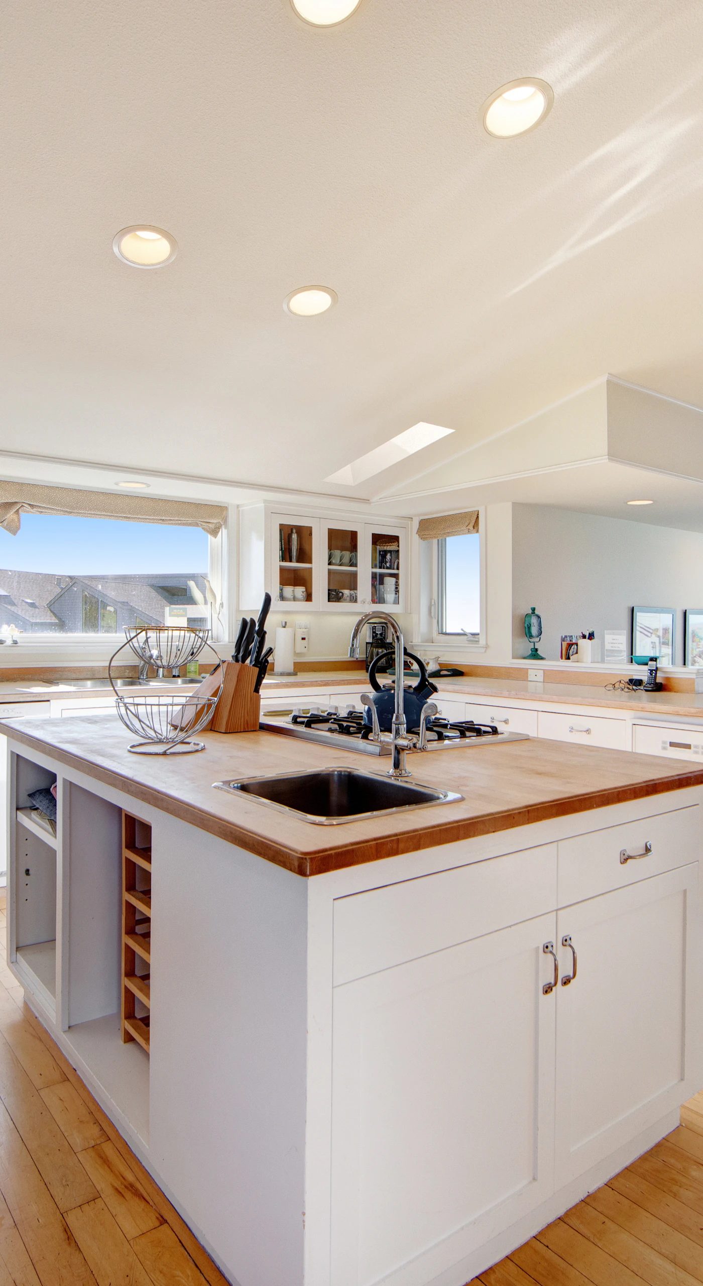 Cook like a local in this bright, open kitchen featuring a center island with wine storage and ocean views.