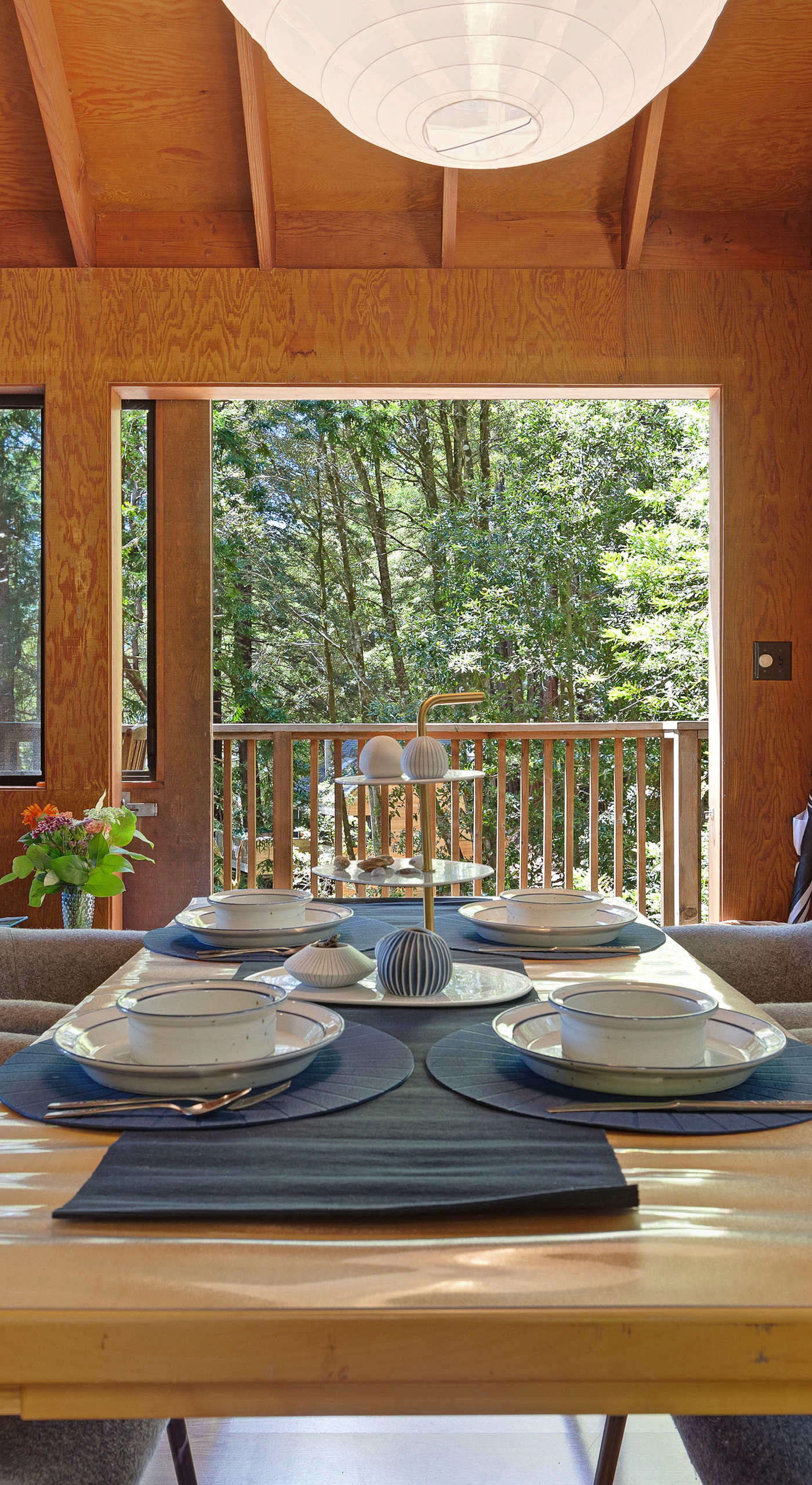 Set the scene for memorable meals in the dining area, where large windows frame the lush outdoors, making every gathering feel special.