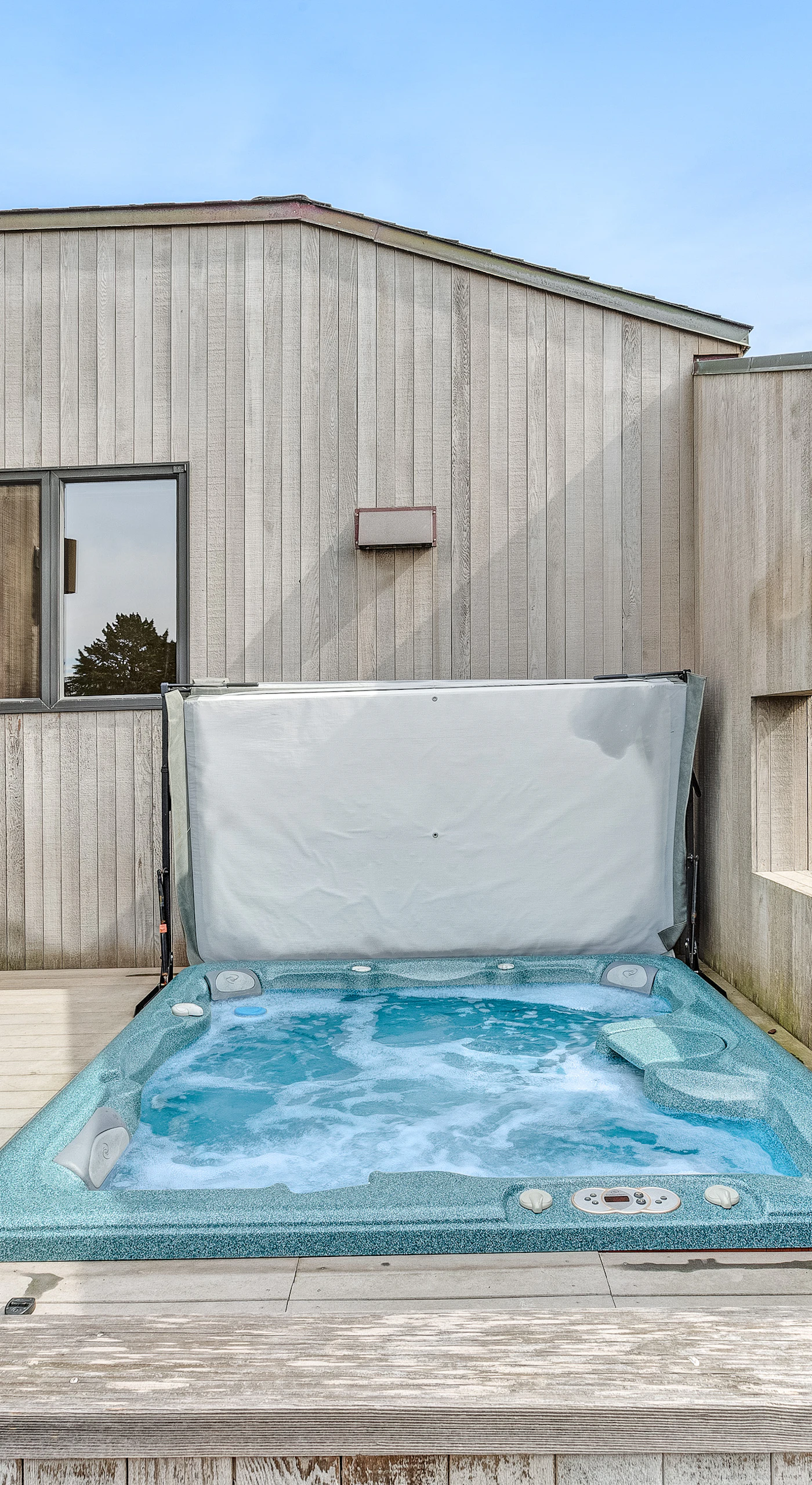 Unwind in the private hot tub on the deck, sheltered from the breeze and just steps from the BBQ grill for a perfect evening on the coast.
