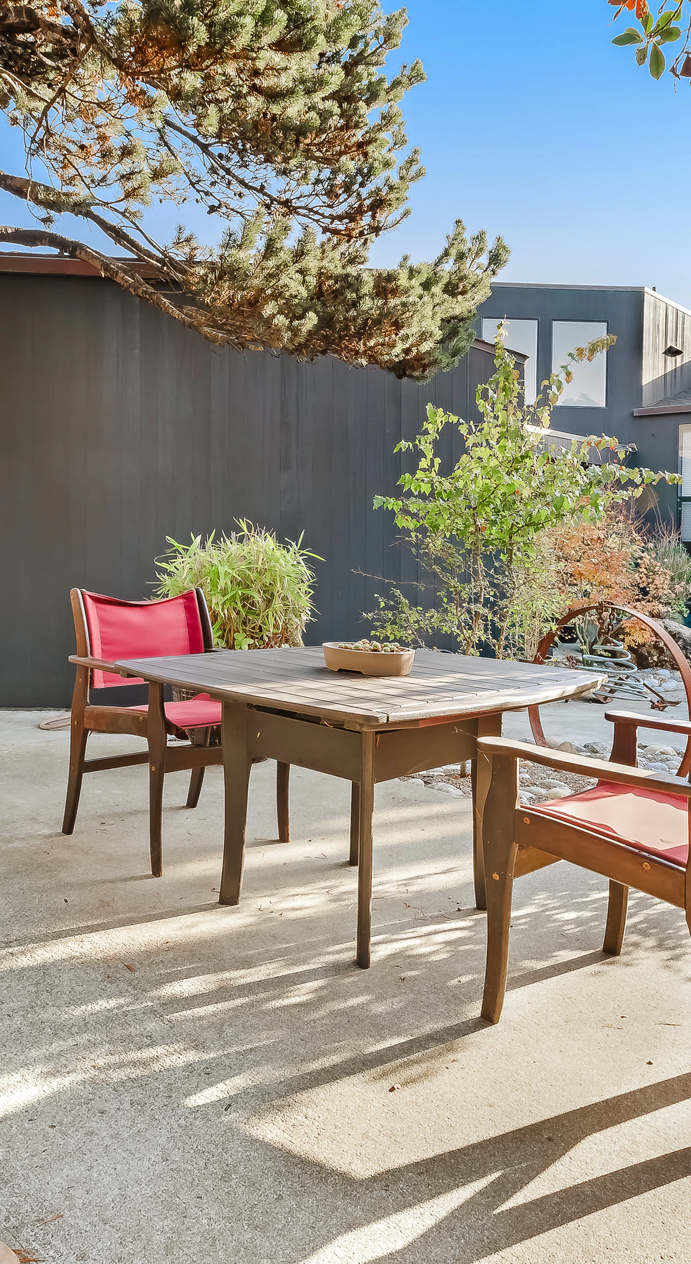 Imagine sipping your morning coffee surrounded by lush landscaping in this serene outdoor retreat.