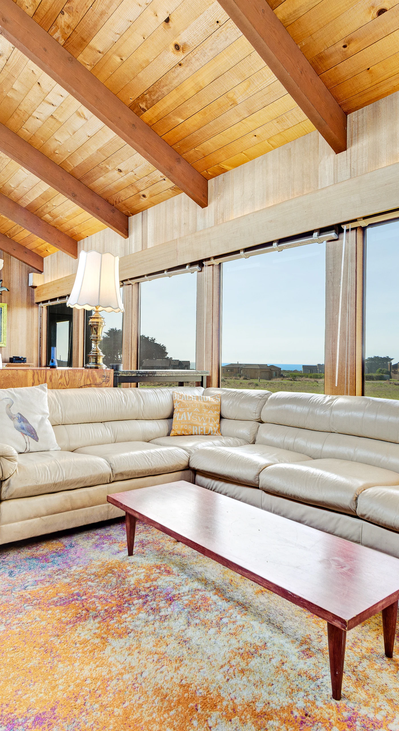 Morning light floods this inviting living room, where you can gather with your loved ones and enjoy stunning ocean views.
