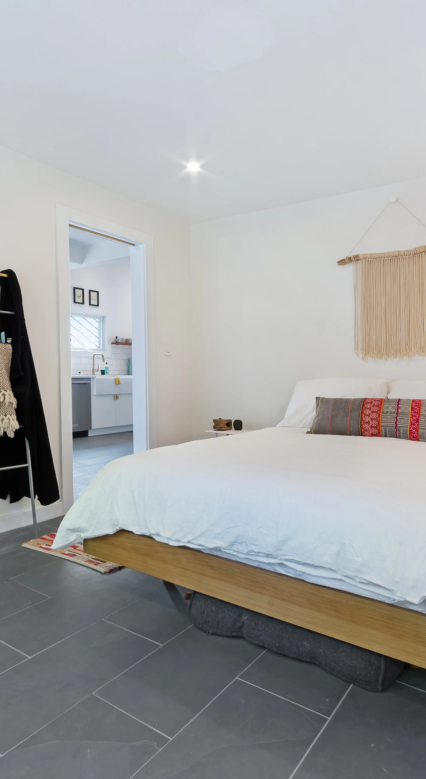 Slide the barn door closed for privacy in your inviting queen bedroom with soft textiles and warm lighting.