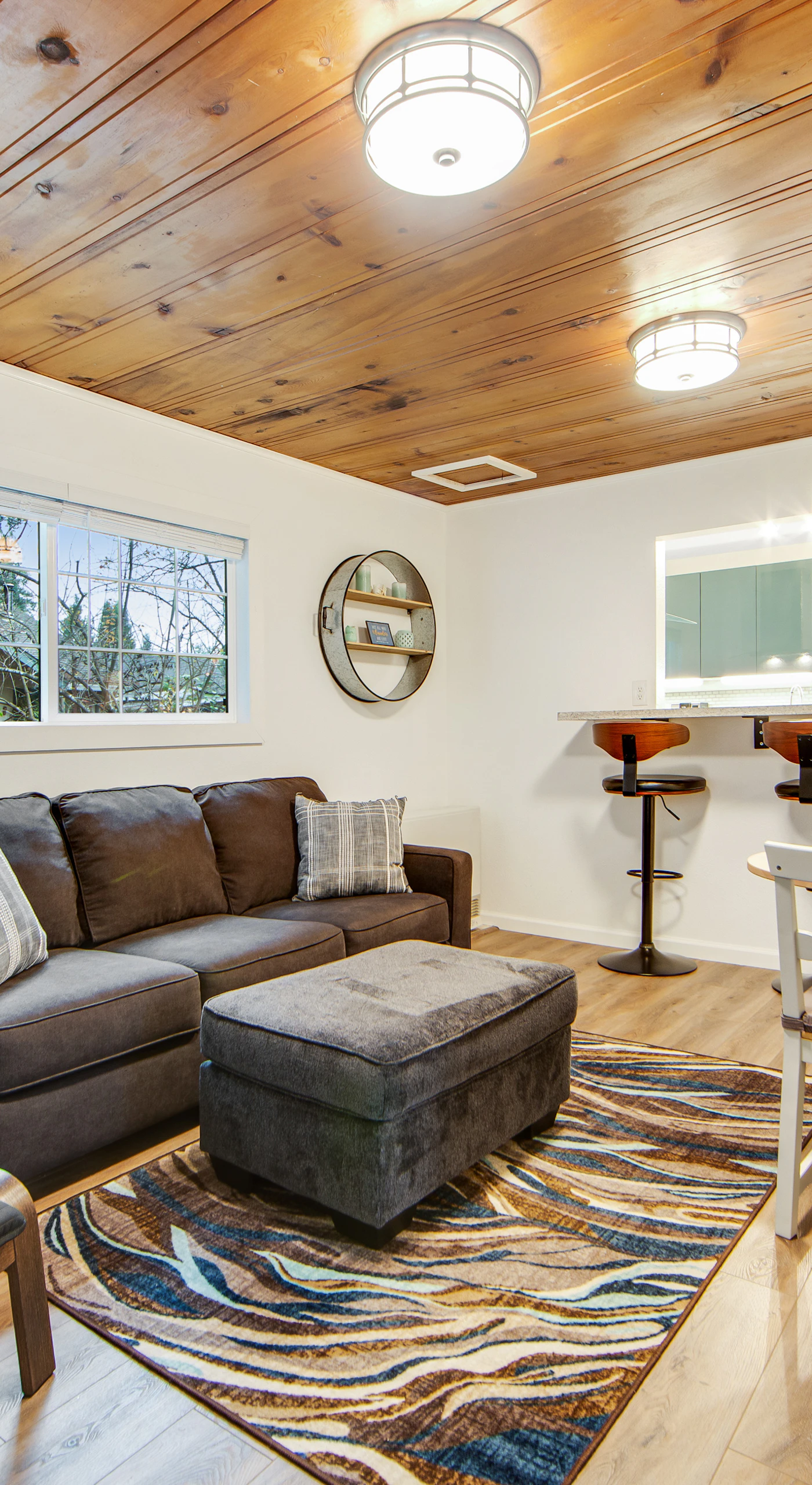 Morning sunlight streams through the windows as you plan your day of winery visits from this inviting living space with warm honey-toned floors and ceilings.