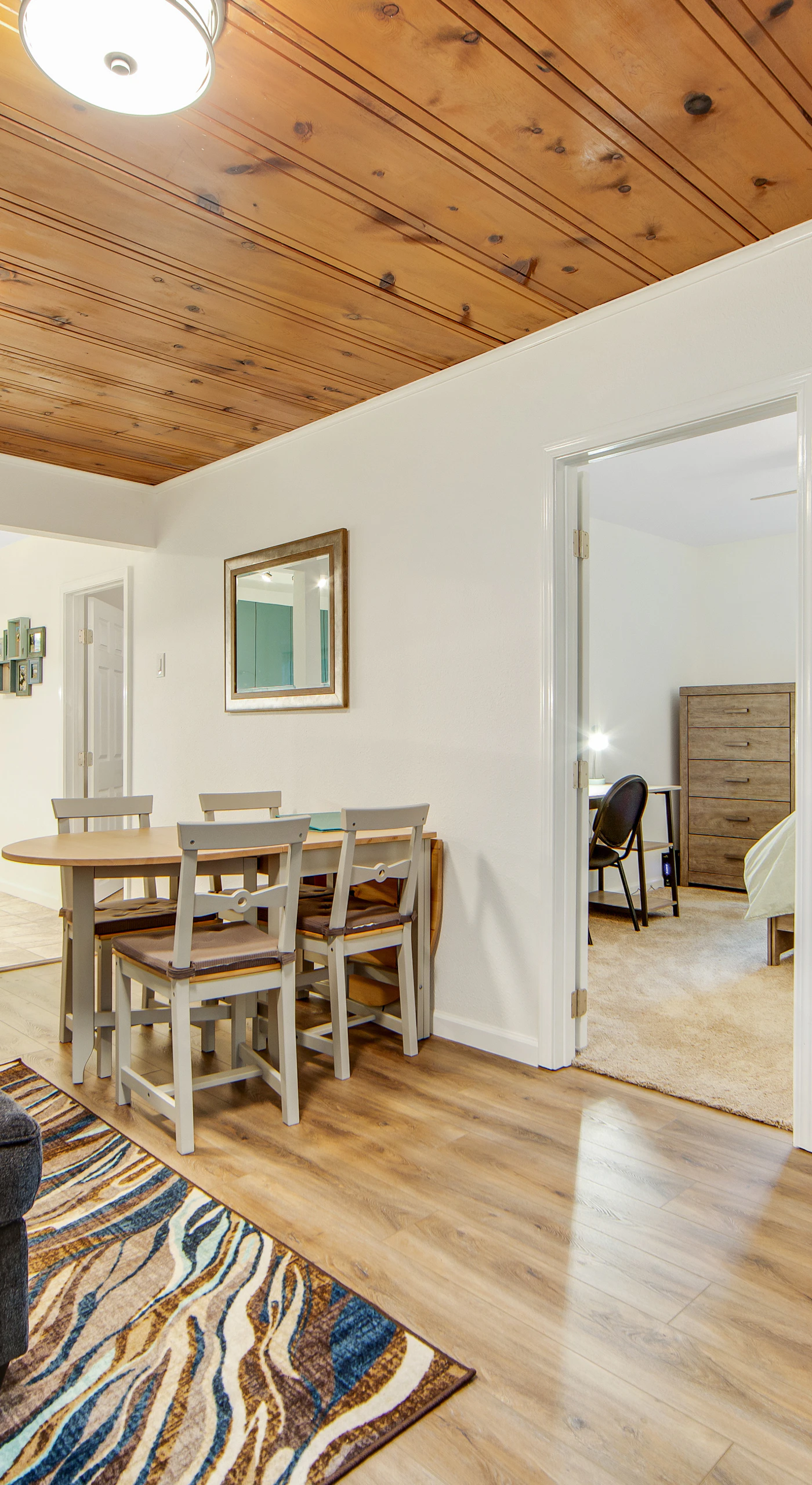 Open-concept living flows effortlessly from the breakfast bar to your entertainment area with a large flat-screen TV — ideal for cozy redwood evenings indoors.