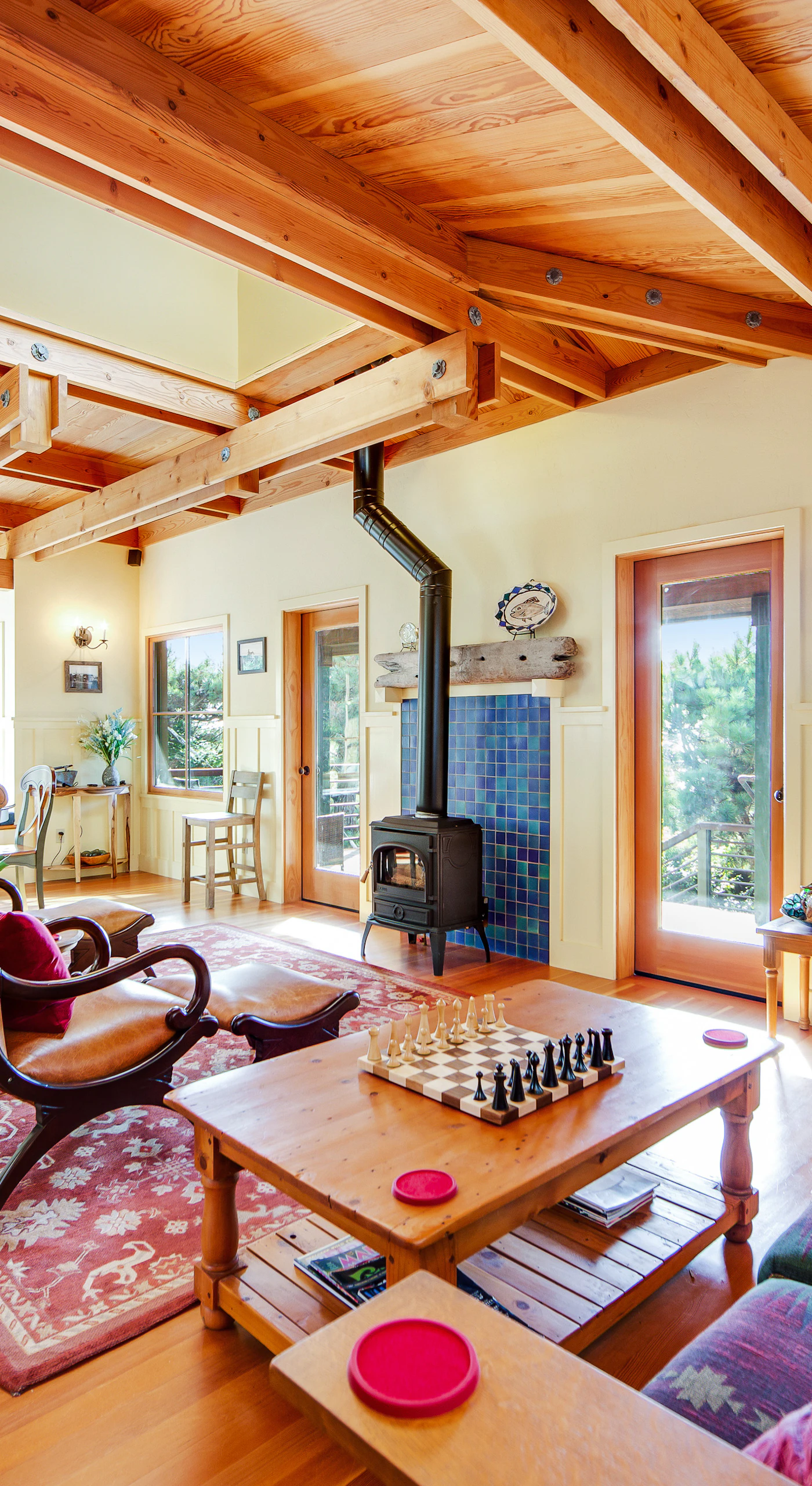 Greet the day in a sunlit living space where ocean breezes flow through large windows, inviting you to relax with a good book.