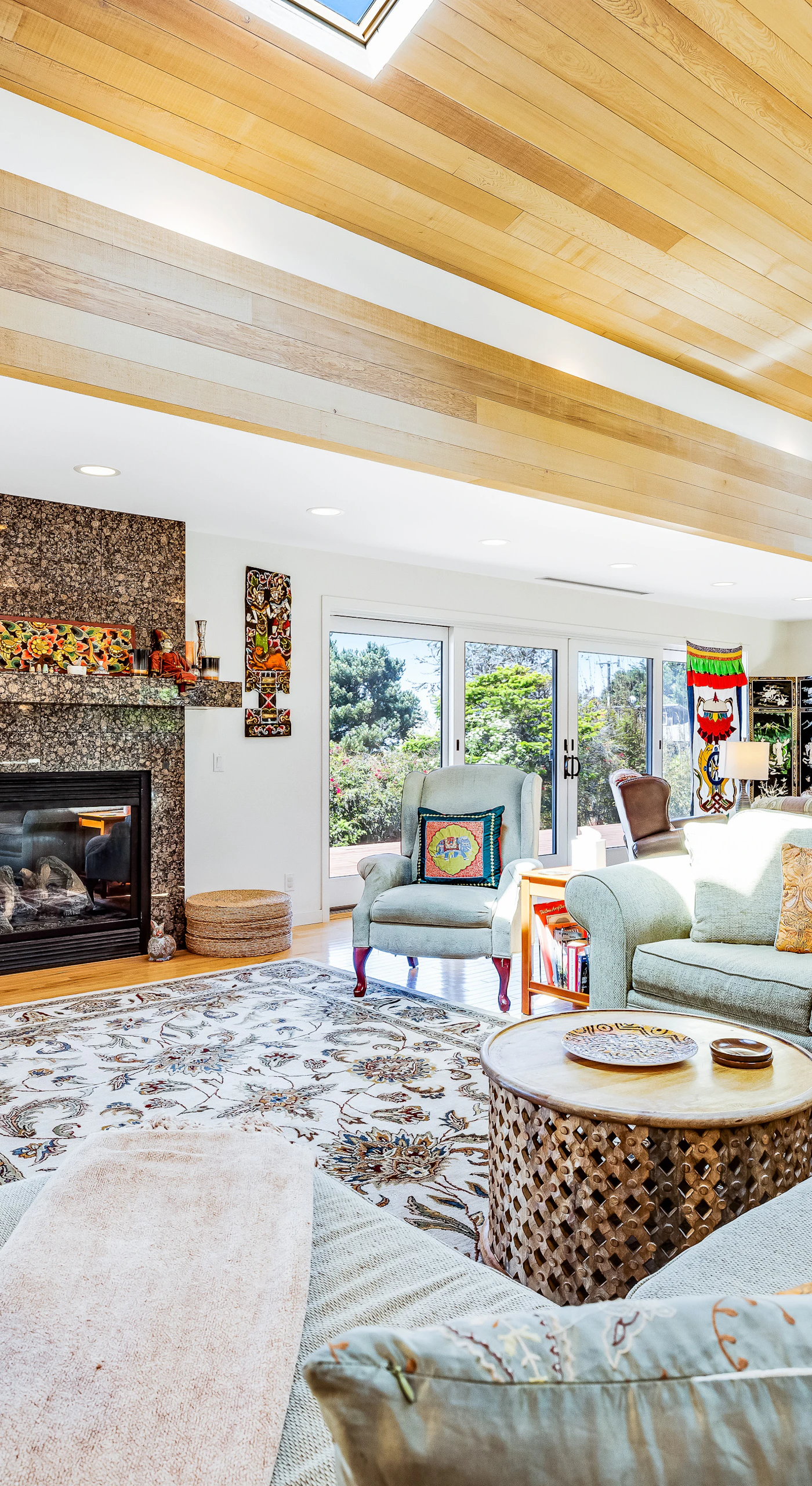 Gather in the spacious living room, where natural light dances off the wood beams and the gas fireplace invites cozy conversations.