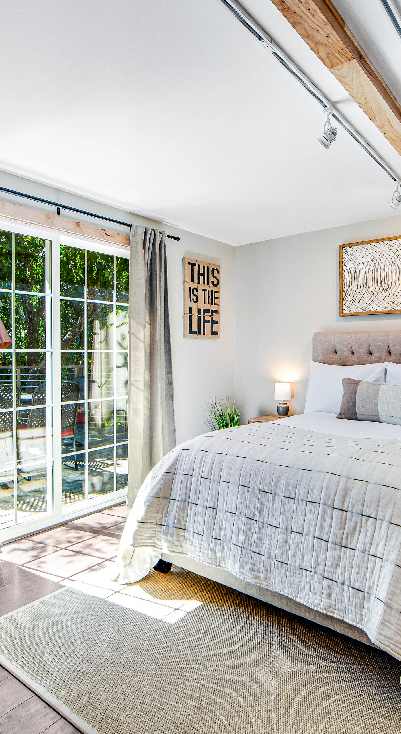 Wake to dappled orchard light through your sliding glass door — step right onto the deck for morning coffee