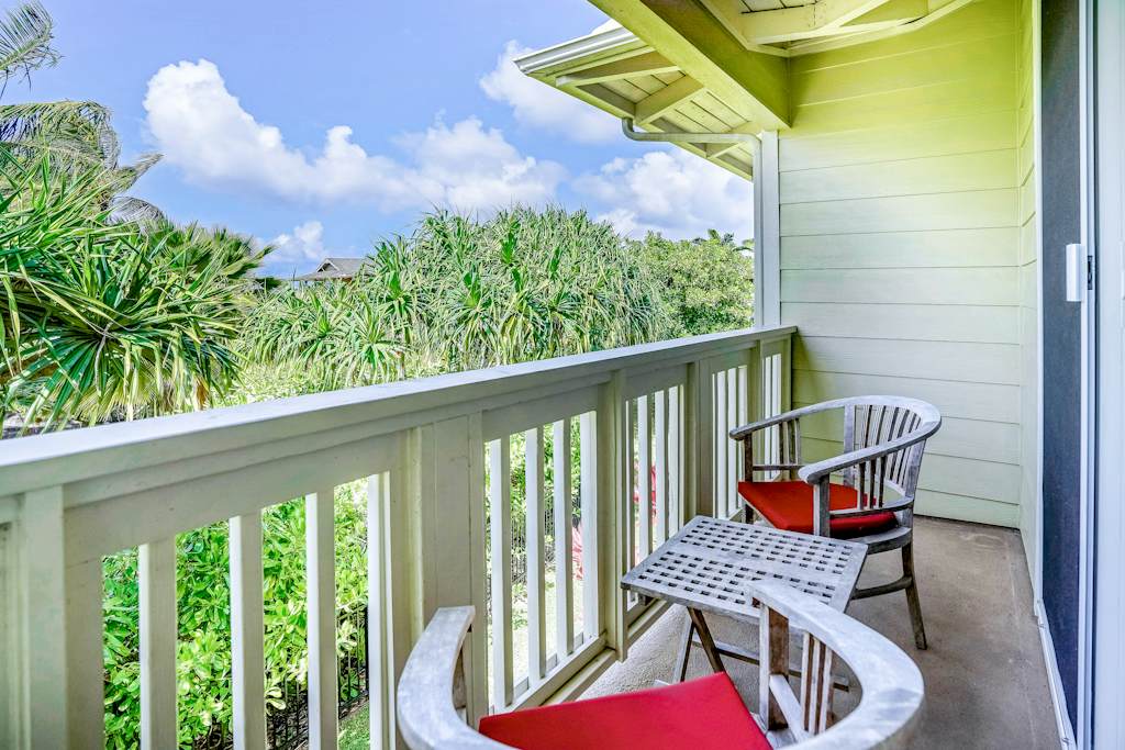 Private lanai surrounded by lush tropical paradise, vibrant flowers, and swaying palms—the perfect place to relax and soak in the island atmosphere.