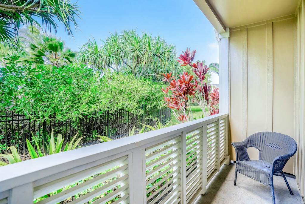 Private lanai surrounded by lush tropical paradise, vibrant flowers, and swaying palms—the perfect place to relax and soak in the island atmosphere.