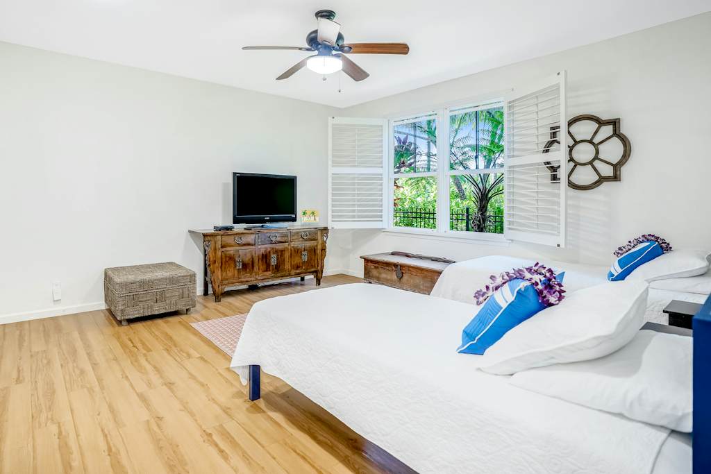 Extra living area with two single beds and a flat screen tv.