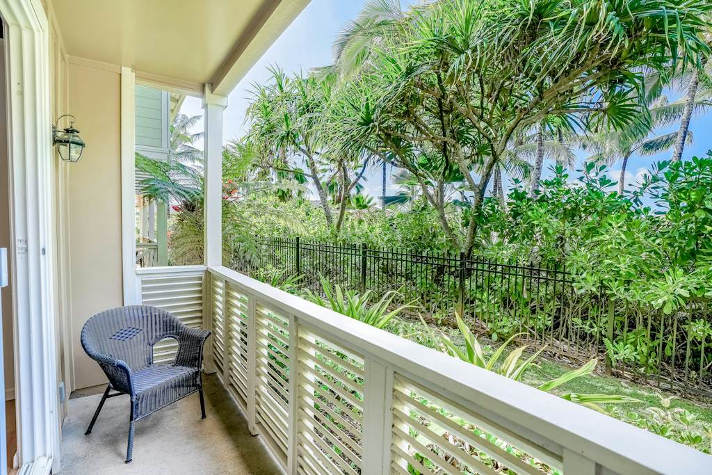 Private lanai surrounded by lush tropical paradise, vibrant flowers, and swaying palms—the perfect place to relax and soak in the island atmosphere.