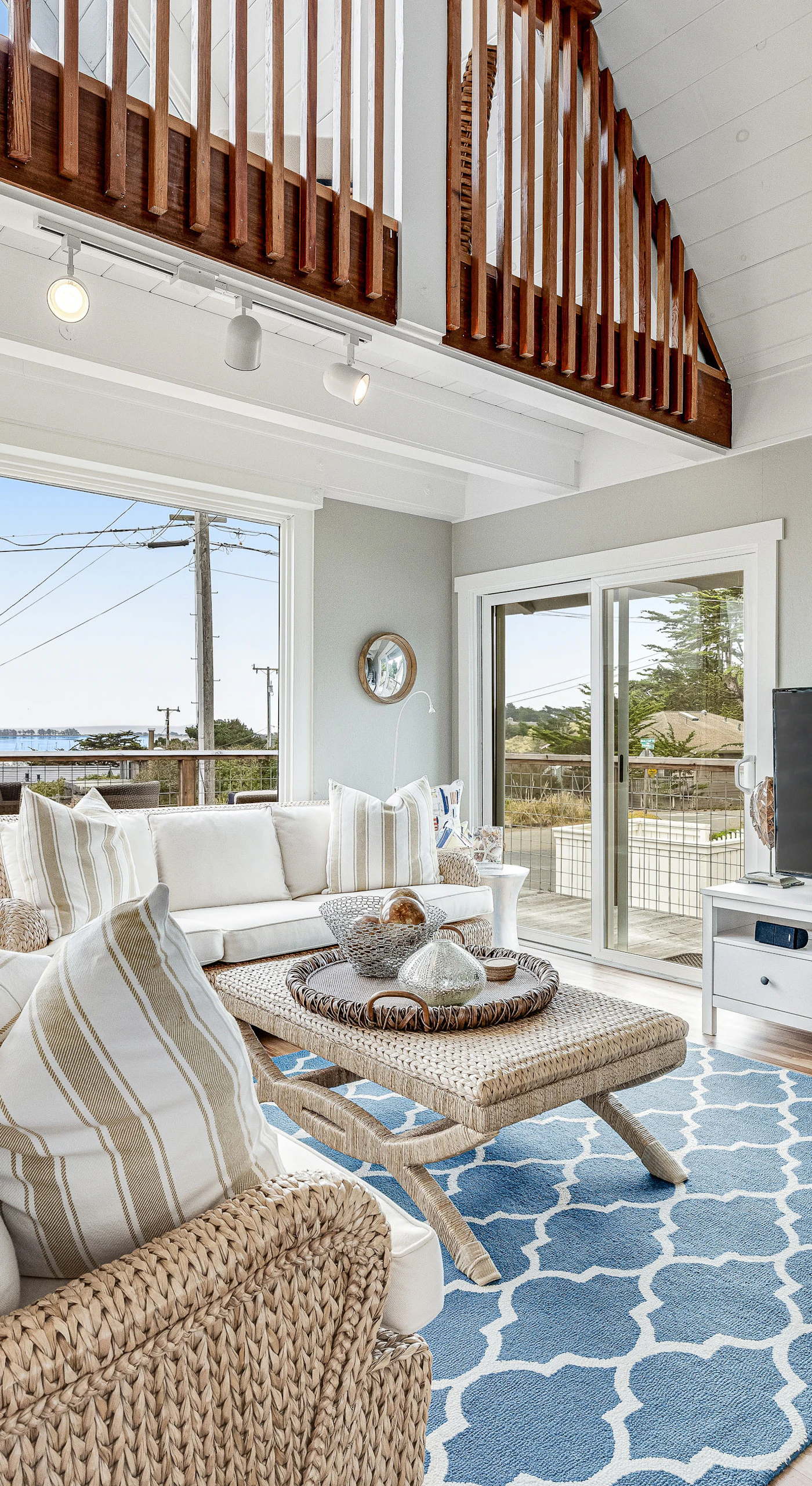 Kick back on the wicker sofa and take in sweeping harbor views through floor-to-ceiling windows — your flatscreen TV is there when the sunsets finally fade.