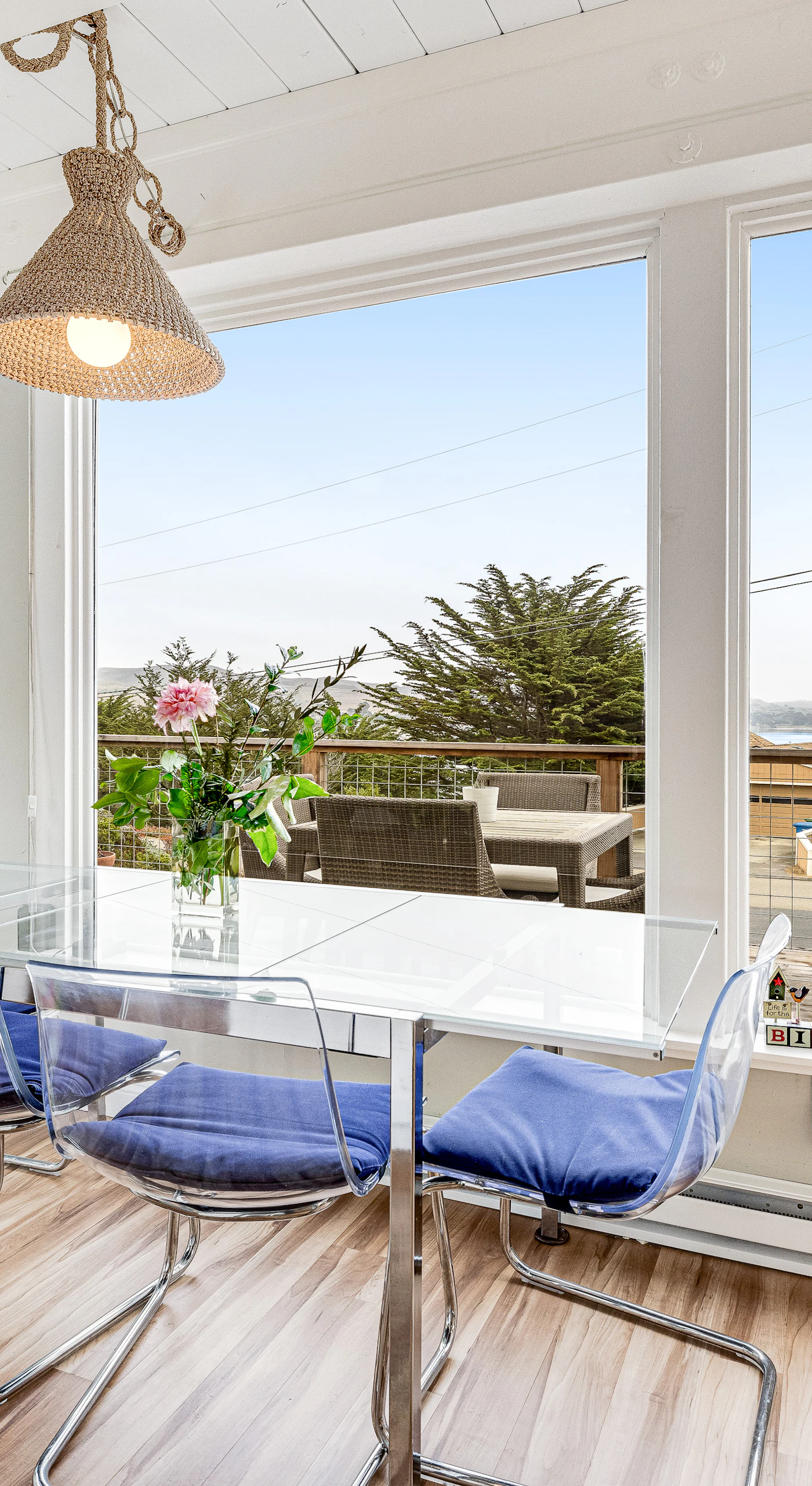 Savor morning coffee at your sunlit dining table with panoramic views of Bodega Harbor — glass walls blur the line between indoors and the bay beyond.