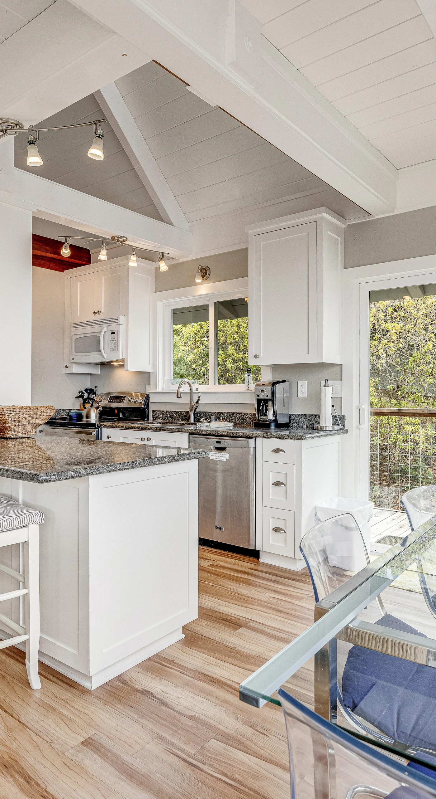 Cook like a local in your bright open kitchen with granite counters, breakfast bar seating, and vaulted ceilings that keep your Bodega Bay evenings airy.