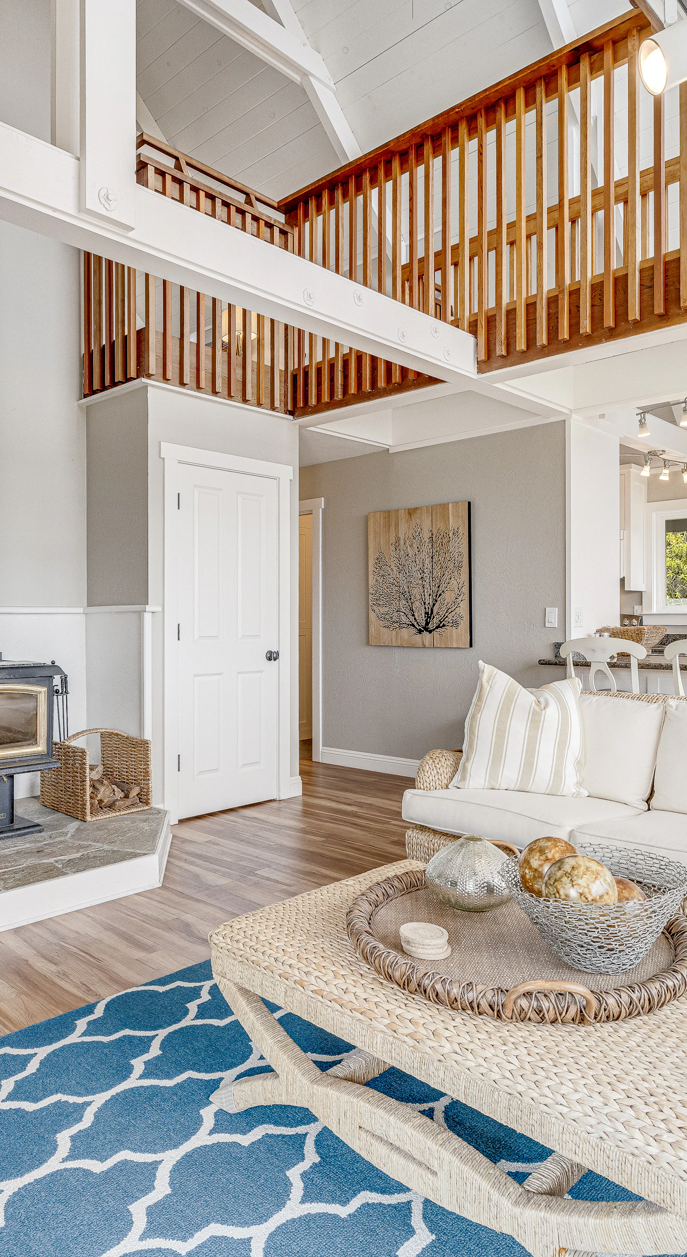 Settle into your sun-drenched great room where a crackling wood-burning stove, vaulted ceilings, and coastal blue accents set the tone for your Bodega Bay escape.