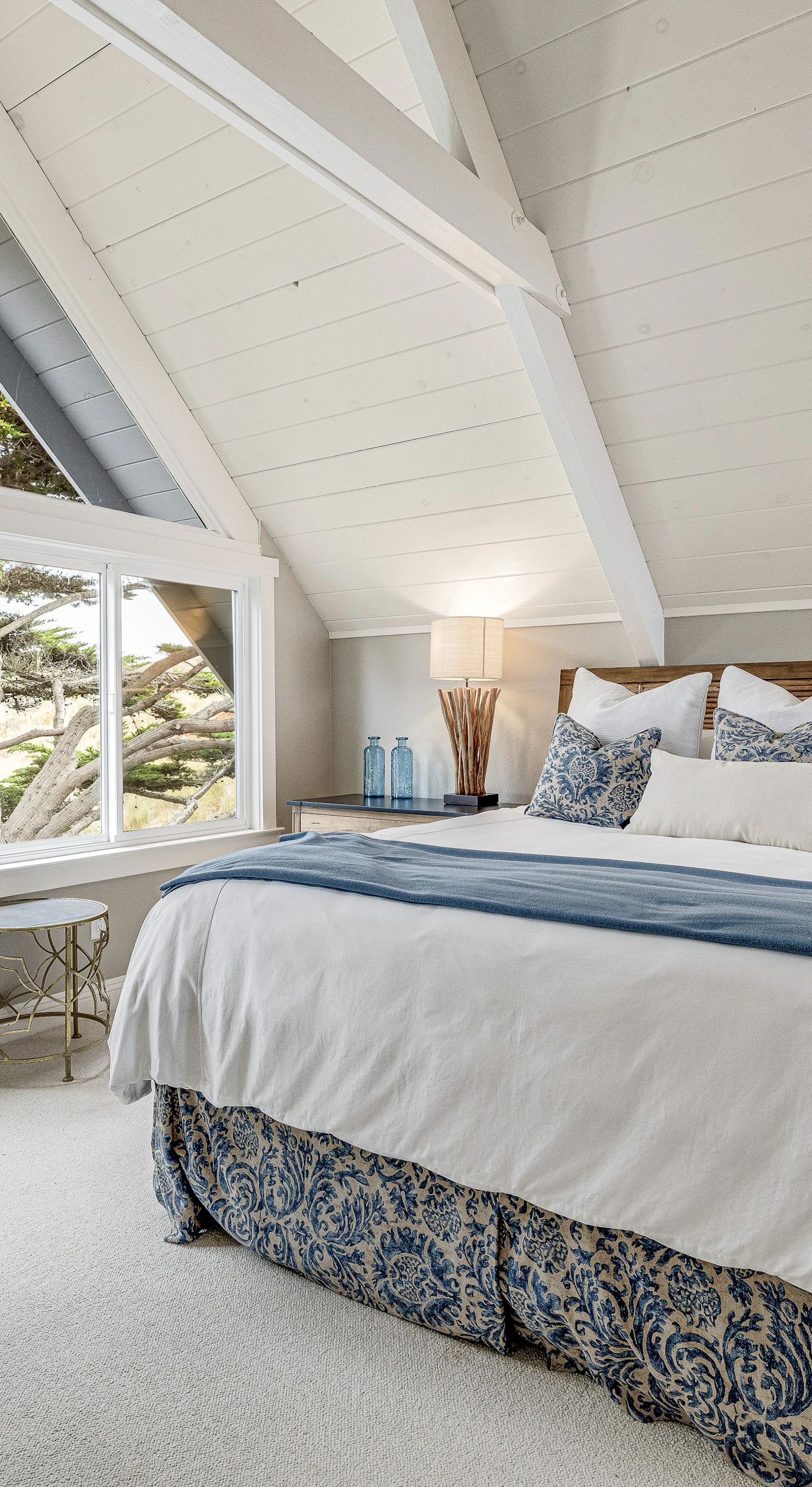 Wake to treetop views through dramatic A-frame windows in your master suite — natural light floods this loft retreat from every angle.
