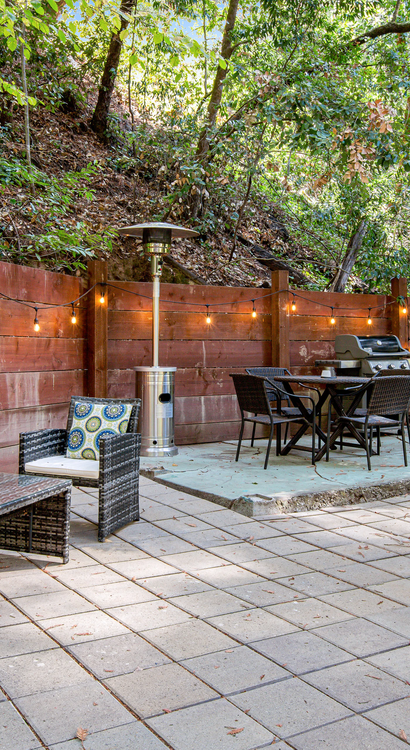 Unwind beneath twinkling string lights on your private patio — lounge seating, outdoor dining, and a cornhole board nestled among towering Guerneville redwoods.