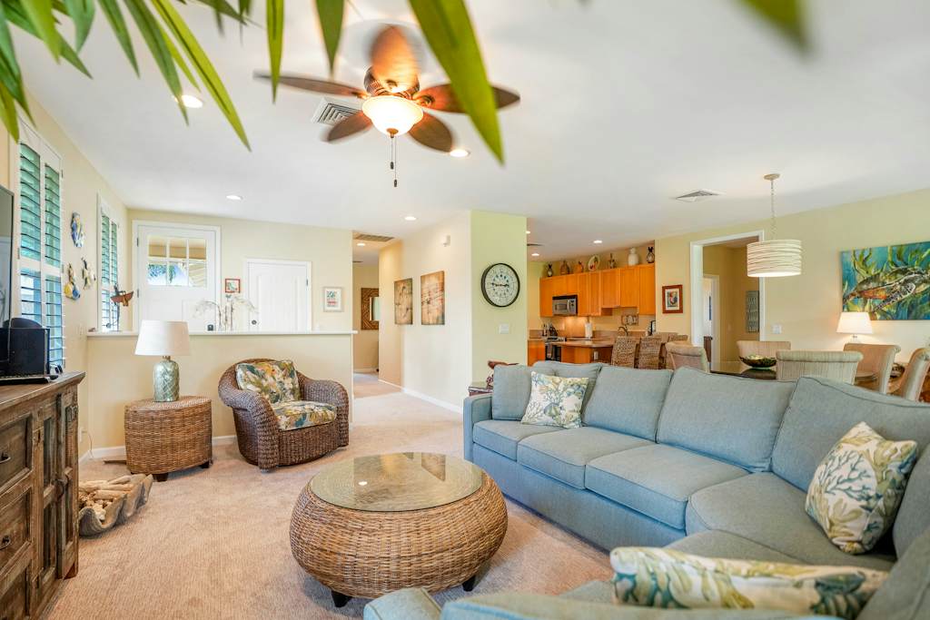 Comfortable living room with plush seating and ceiling fan
