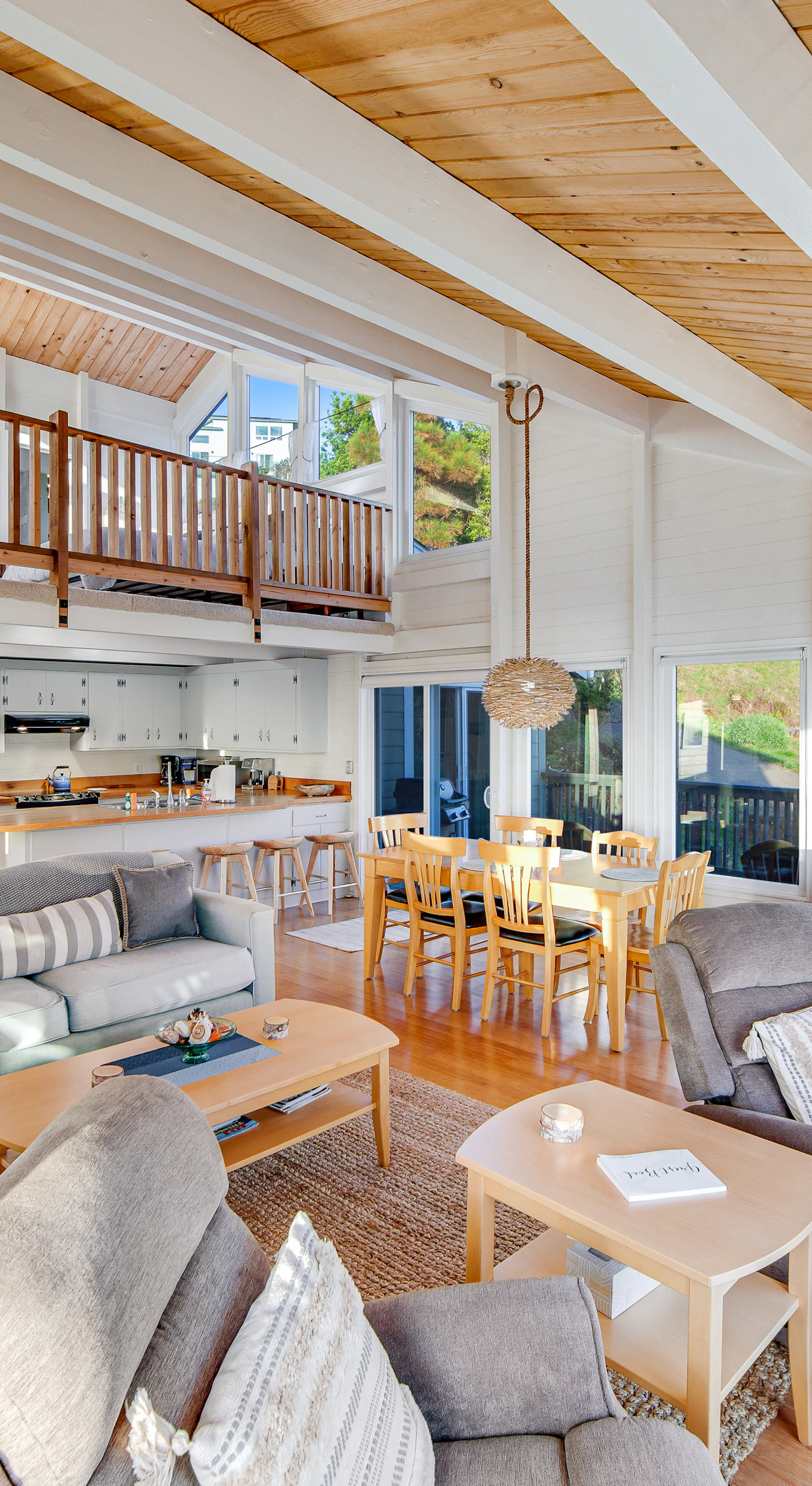 Step into a welcoming space filled with natural light, where you can gather around the wood-burning fireplace after a day of coastal adventures.