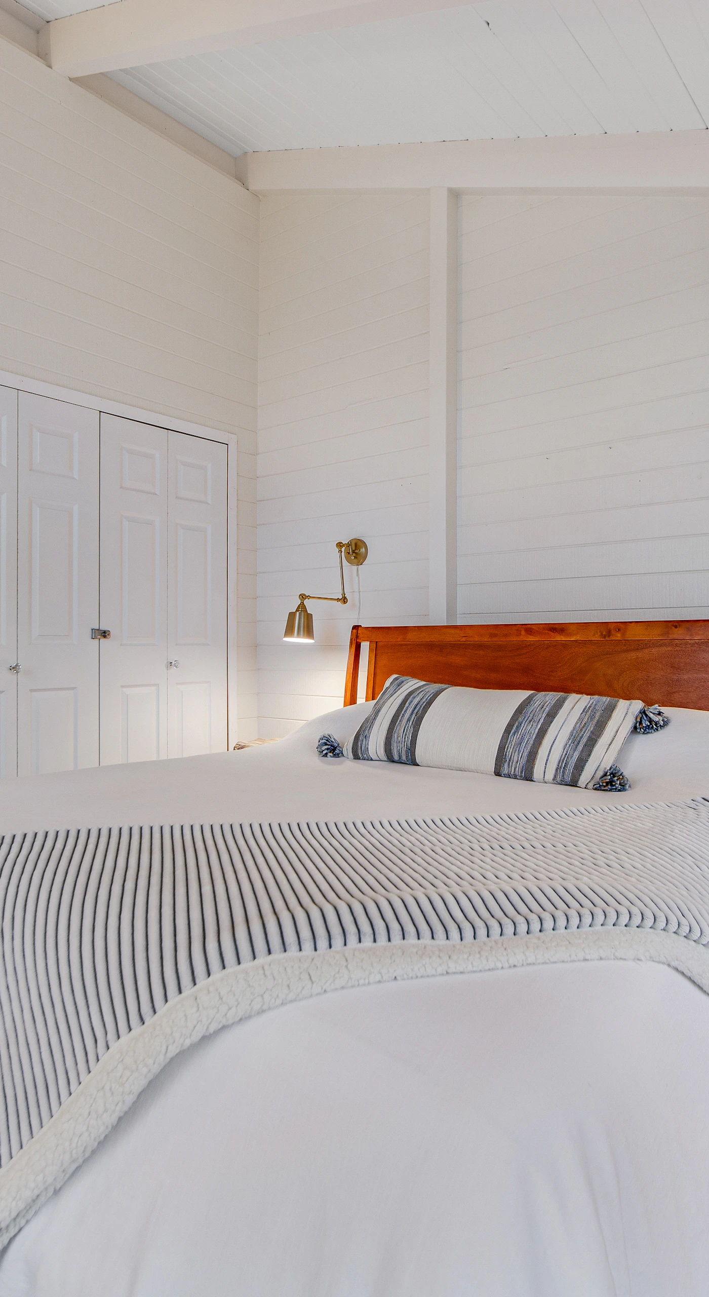 Retreat to the tranquil master bedroom, where soft linens and elegant decor create a peaceful haven after a day by the sea.