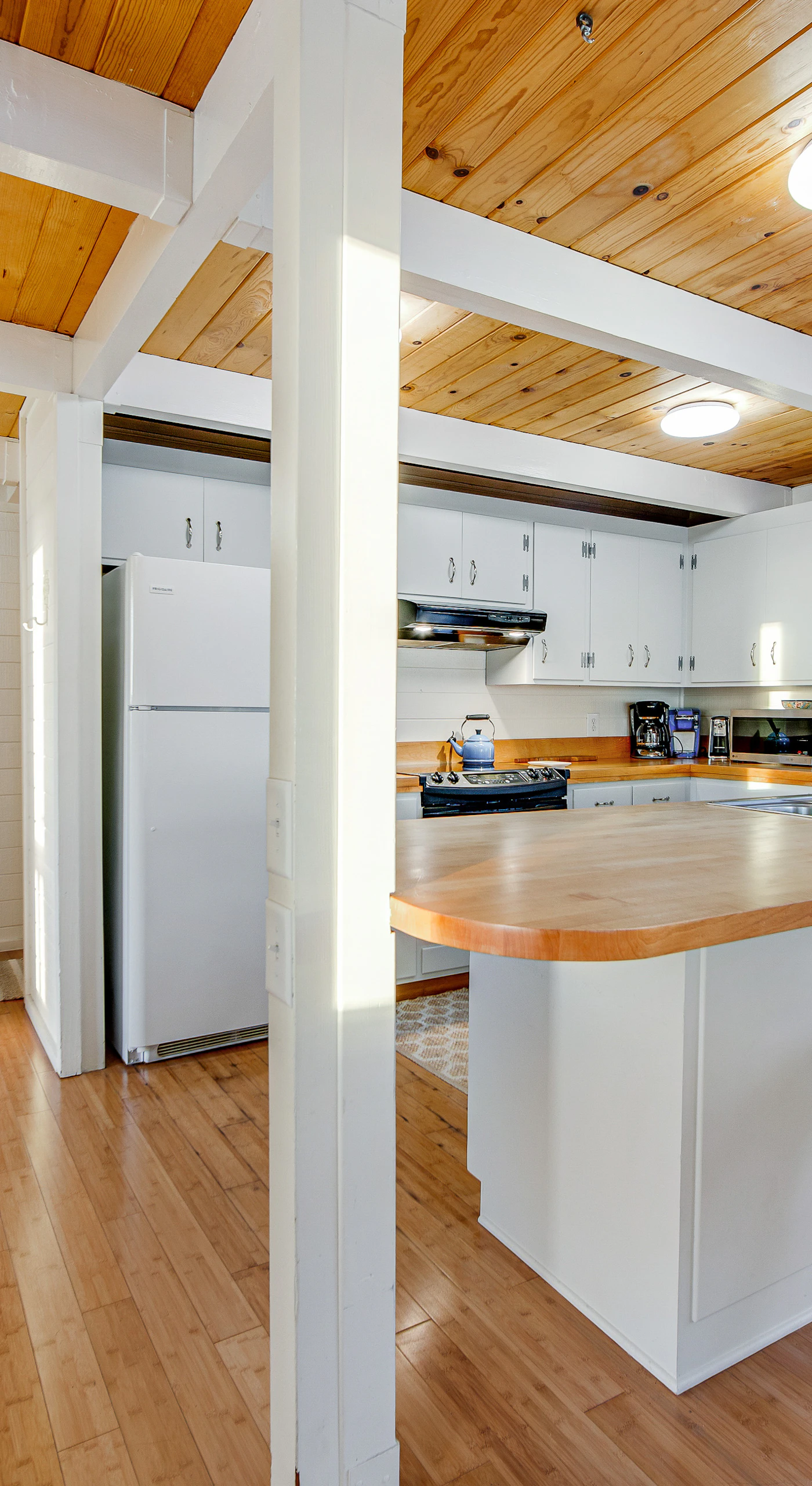 Create culinary delights in this spacious kitchen, designed for both cooking and socializing, while enjoying the coastal charm.