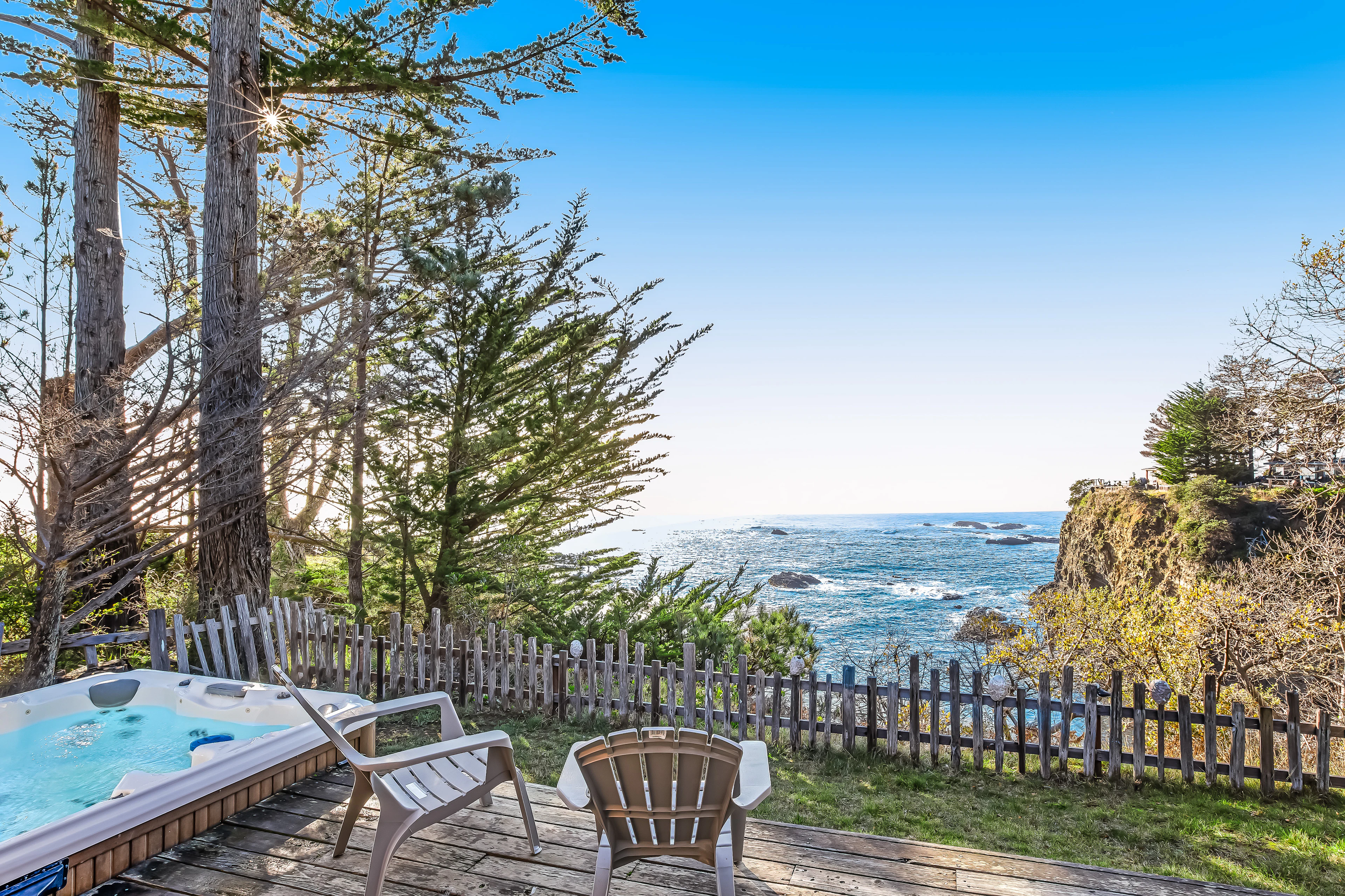 Nestled among the trees, your private hot tub offers a tranquil escape, where you can unwind while gazing at the stunning ocean scenery.