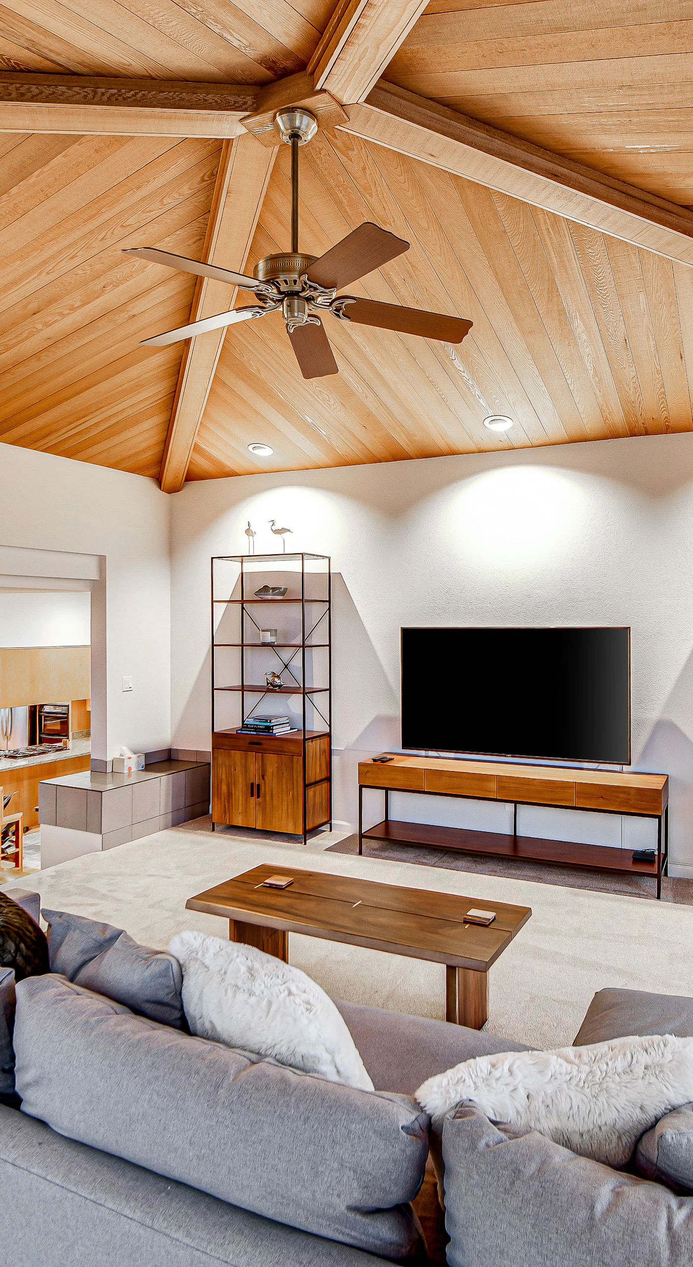 Cozy up for movie night with a large flat-screen TV, deep sectional seating, and your gas fireplace crackling just steps away