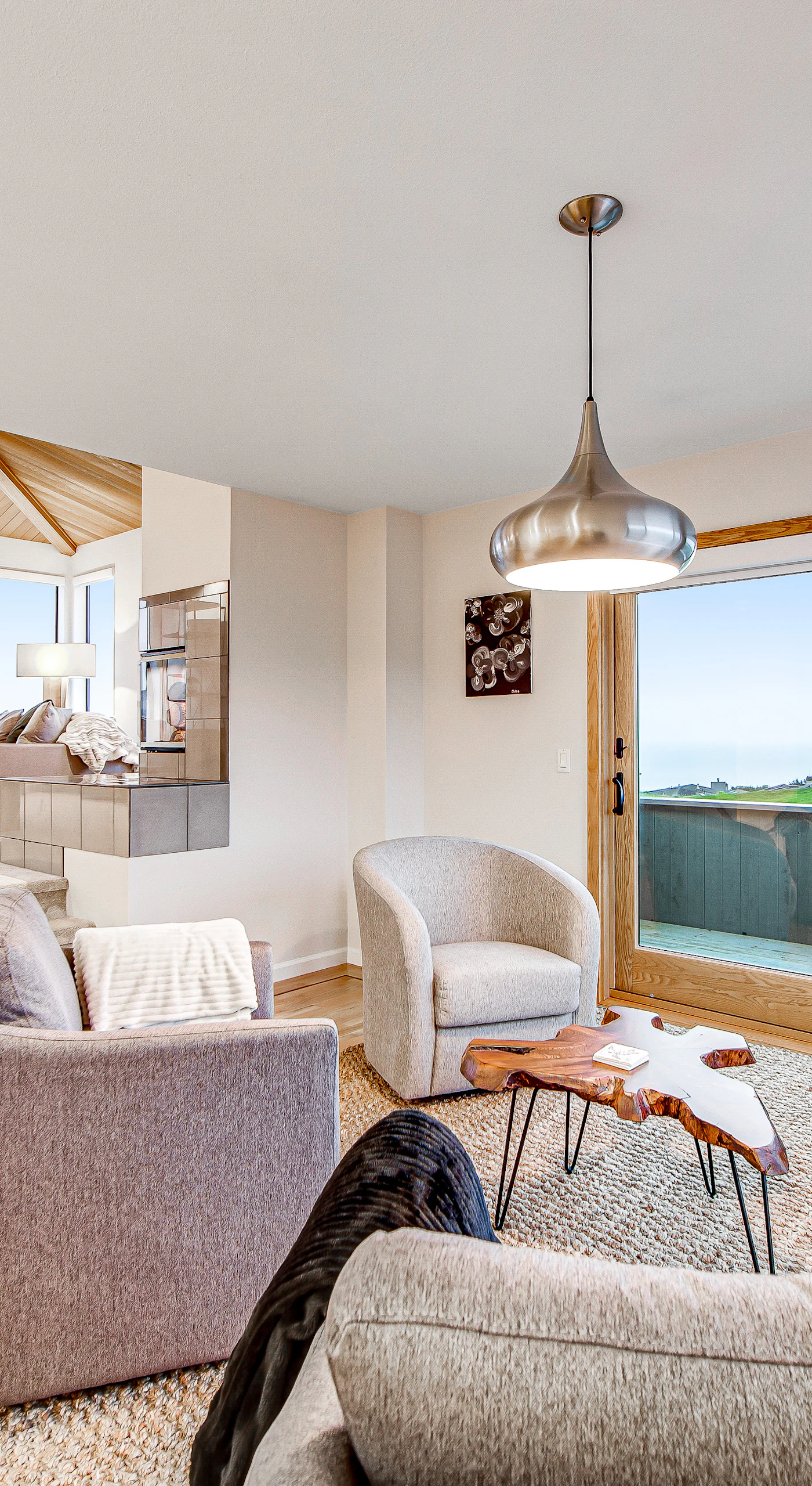 Settle into your sun-drenched living area where hardwood floors, modern furnishings, and floor-to-ceiling glass frame the Bodega Bay coastline