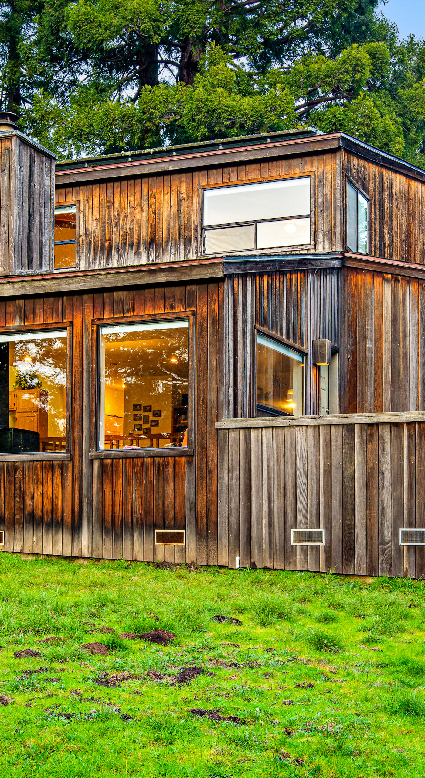 The inviting exterior of The Bobcat House showcases its unique character, nestled in nature for a peaceful escape.