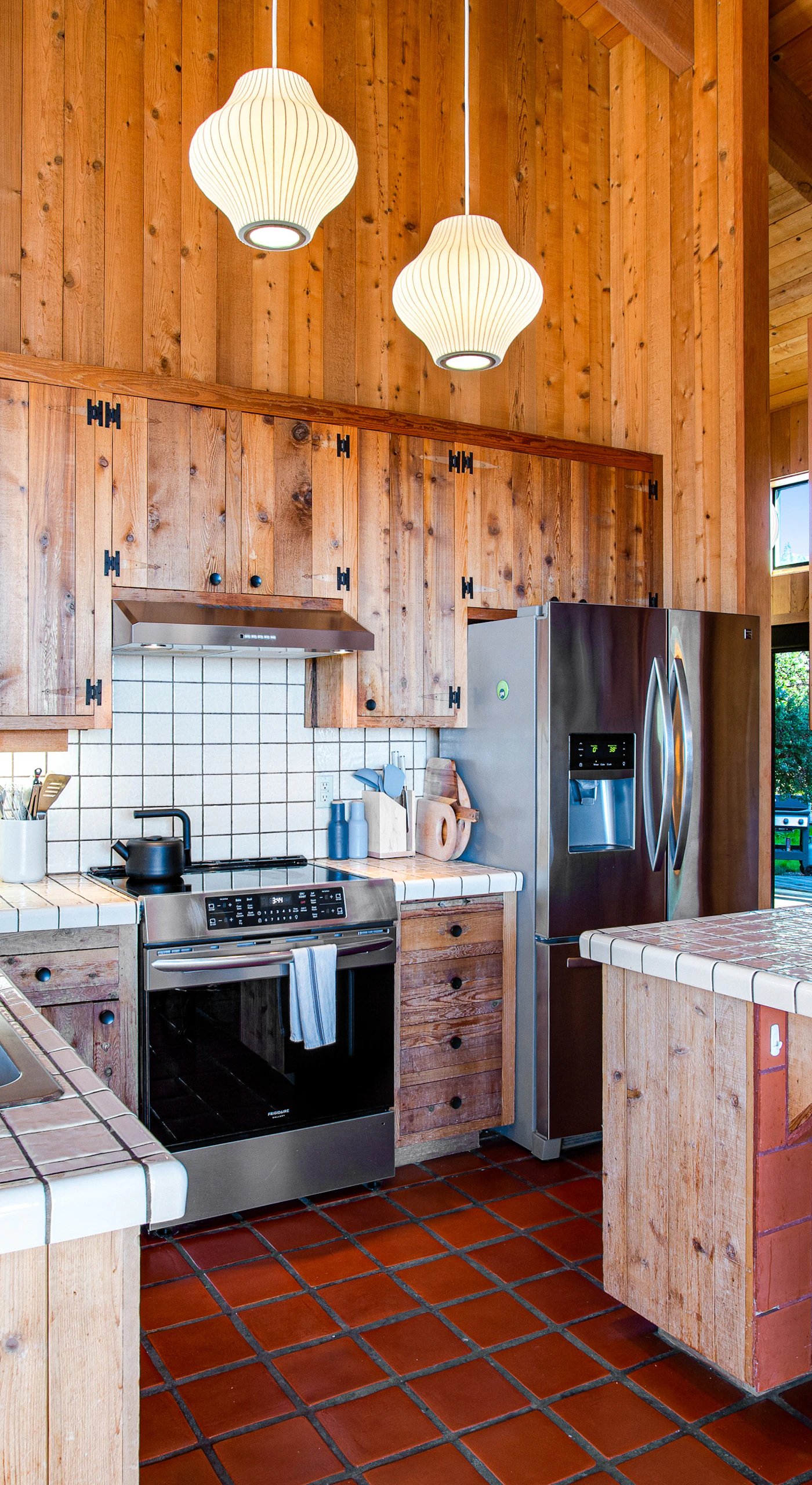 Enjoy gathering around the spacious kitchen, complete with a cozy wood stove, perfect for warming up after a day by the beach.