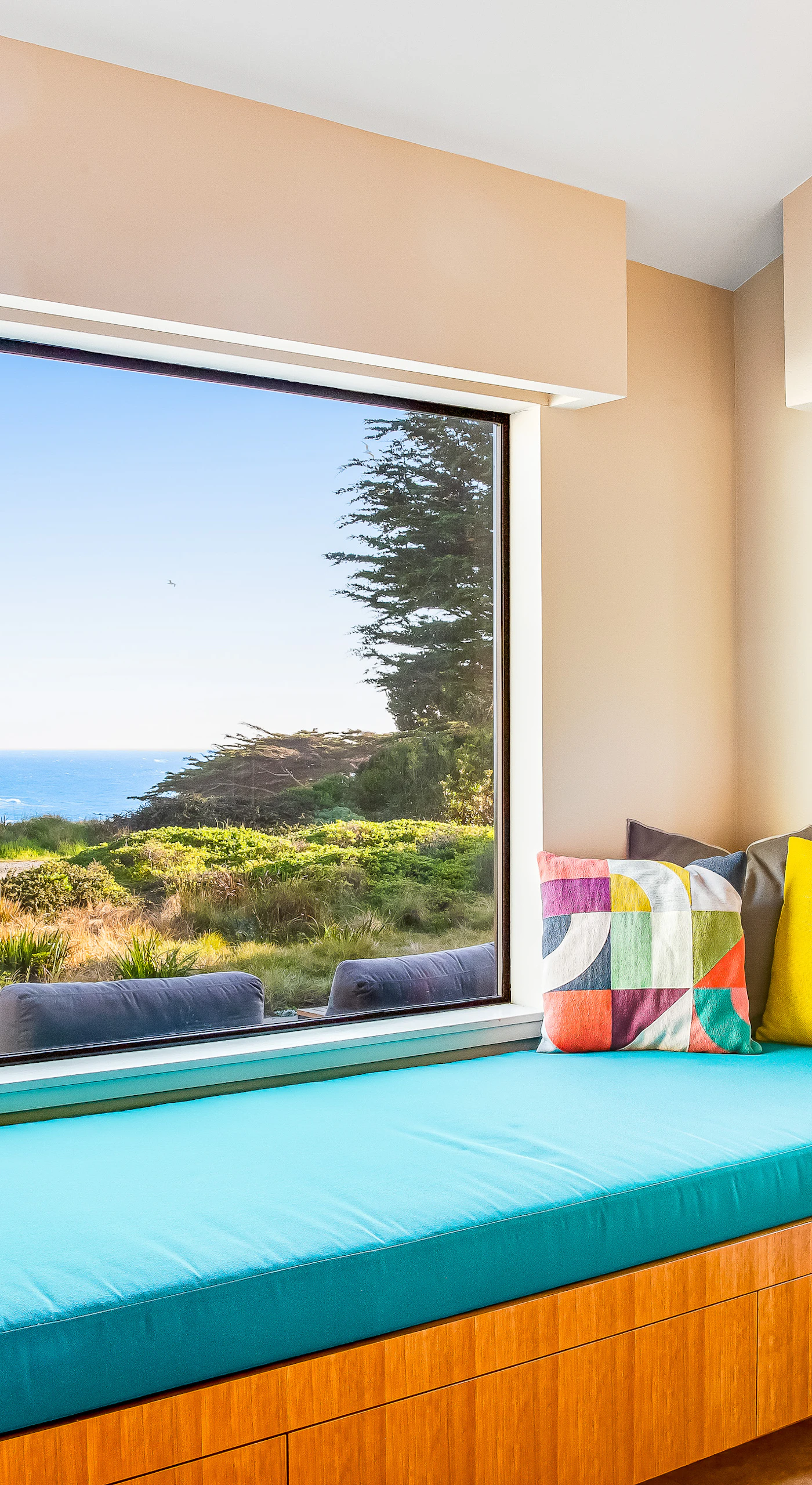 This serene window seat offers the perfect spot to daydream or sip your favorite drink as the coastal breeze drifts by.