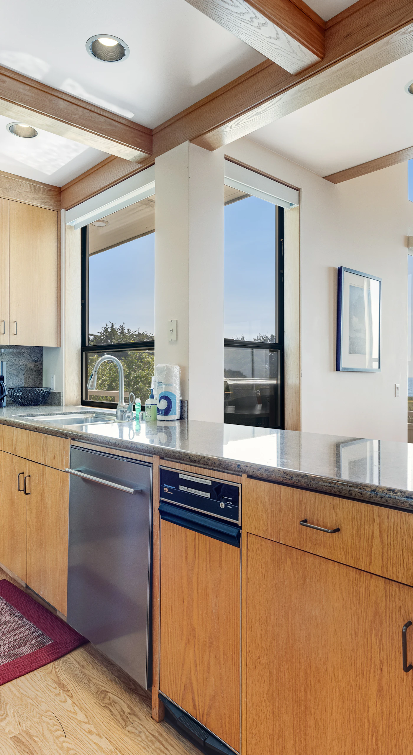 Enjoy effortless meal prep in this modern kitchen, where every detail enhances your cooking experience against a backdrop of ocean beauty.
