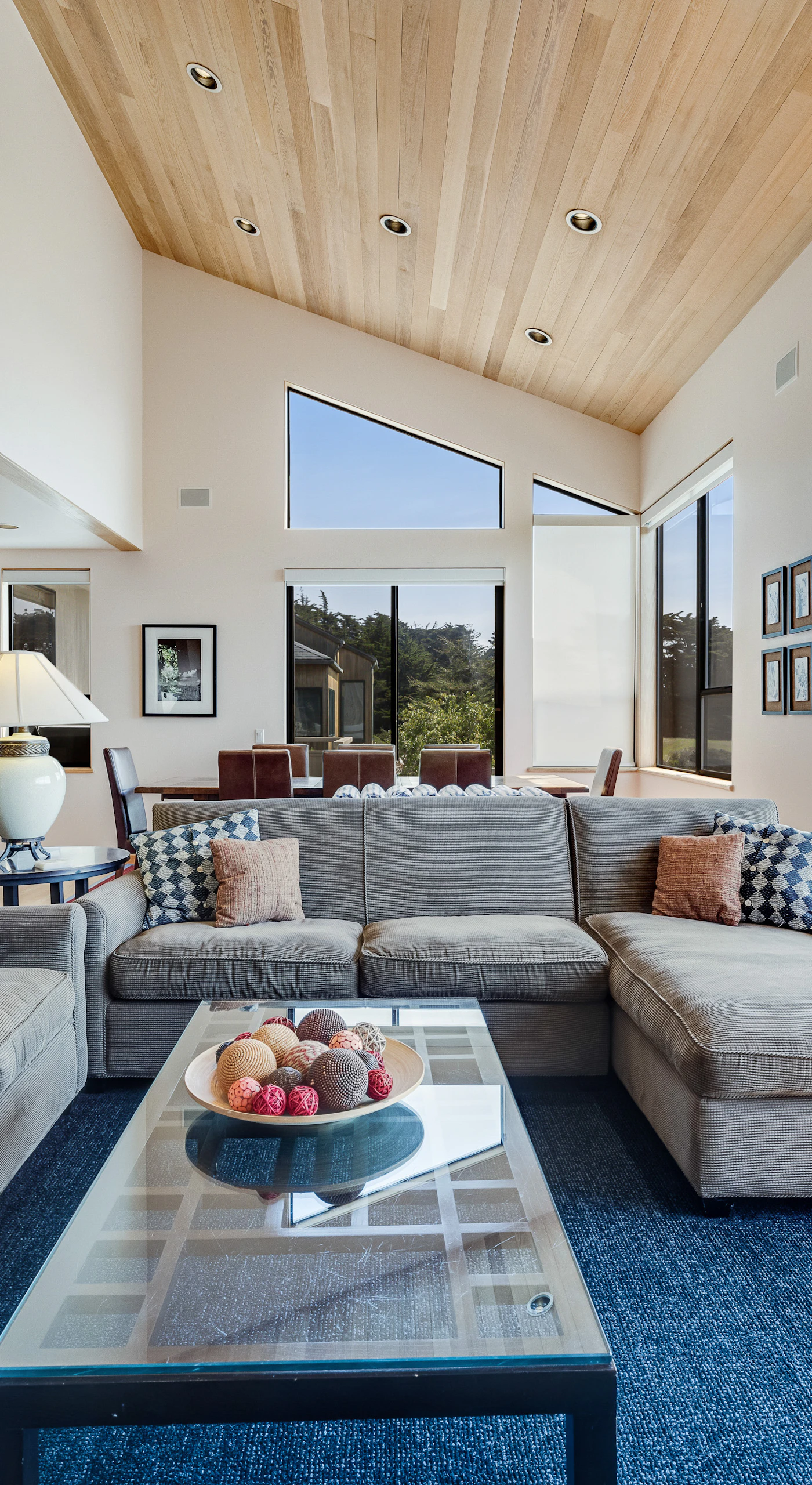 Gather in this inviting living room, where natural light pours in, creating the perfect atmosphere for cozy evenings by the wood-burning fireplace.