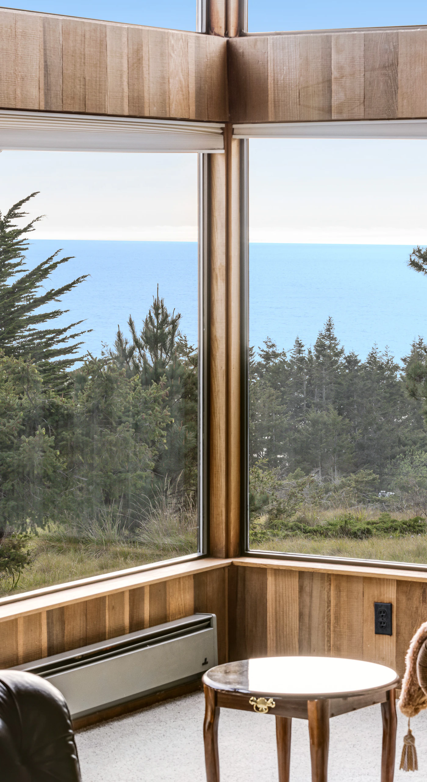 Bask in the glow of the wood-burning fireplace while soaking in breathtaking ocean views through floor-to-ceiling windows.
