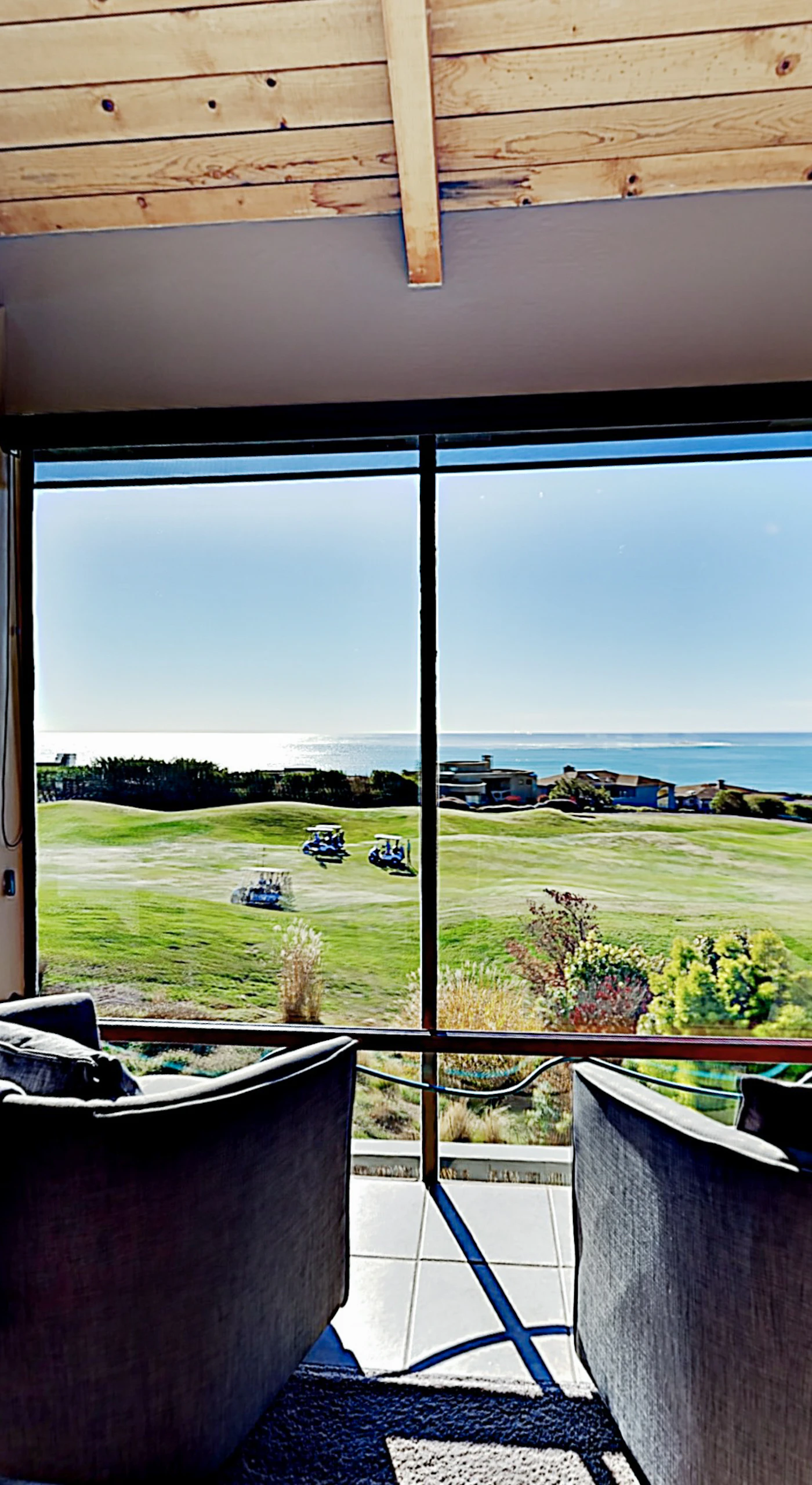 Your living room doubles as a private viewing lounge — watch Bodega Bay's coastal drama unfold through a wall of glass stretching from fairway to whitecaps.