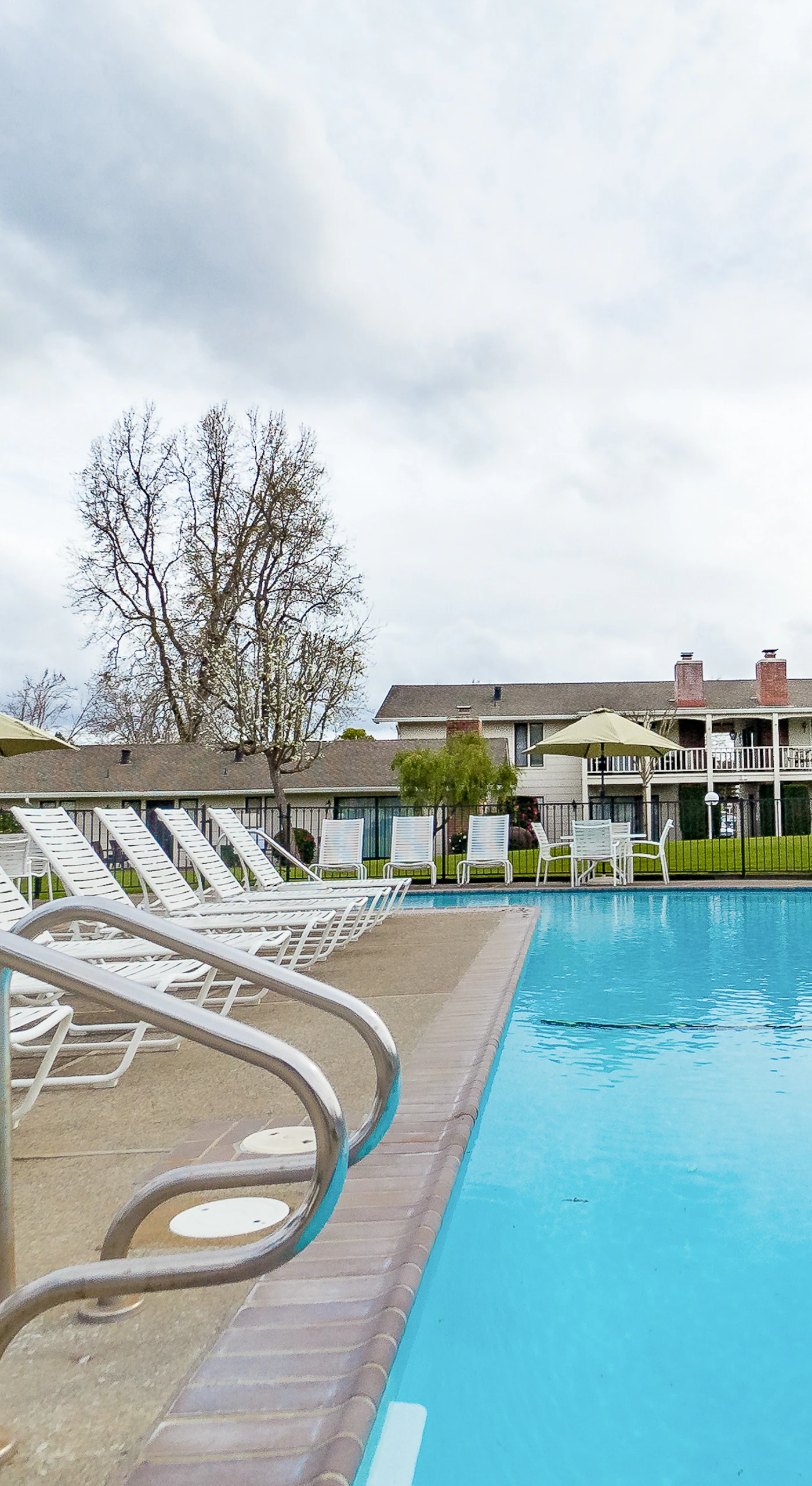 Dive into crystal-clear water surrounded by classic Napa Valley resort architecture — your poolside afternoon is calling.
