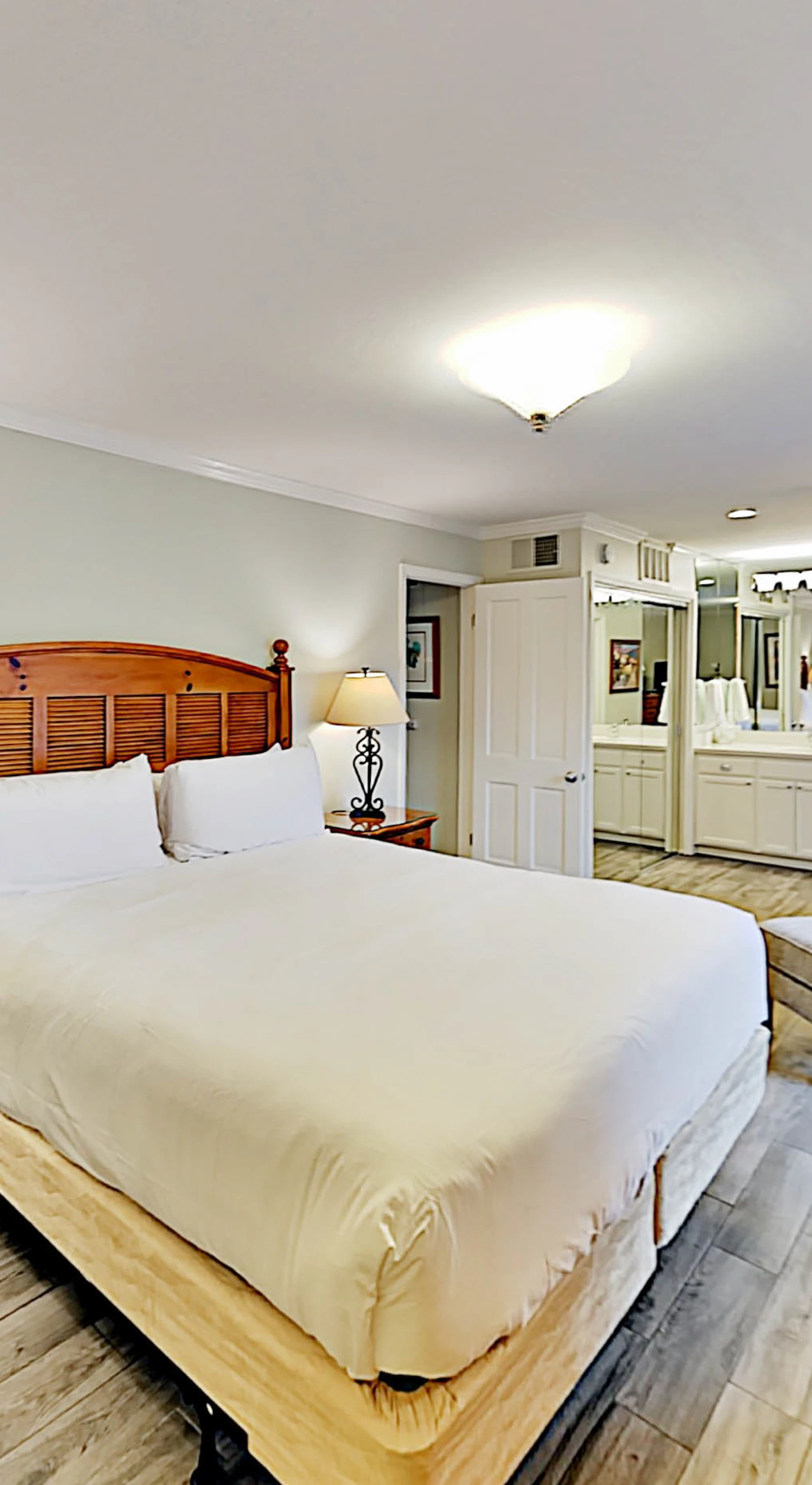 Sink into your plush king bed dressed in crisp white linens — this serene Napa Valley master suite is your ultimate wine country sanctuary.