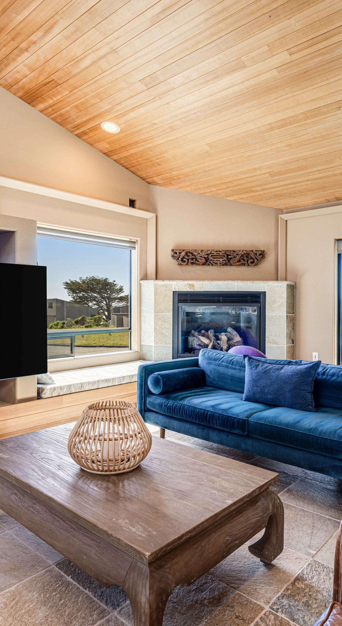 Gather in the living room, where natural light pours in and the warmth of the gas fireplace creates an inviting atmosphere.