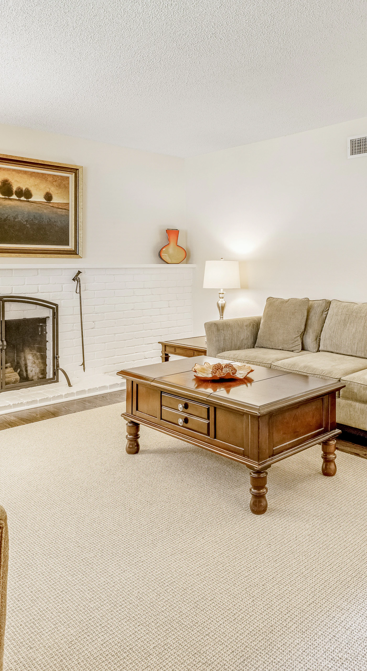 Sink into your cozy living room after a day of Kenwood wine tasting — a white brick fireplace, plush seating, and warm lighting set the scene for relaxing evenings.