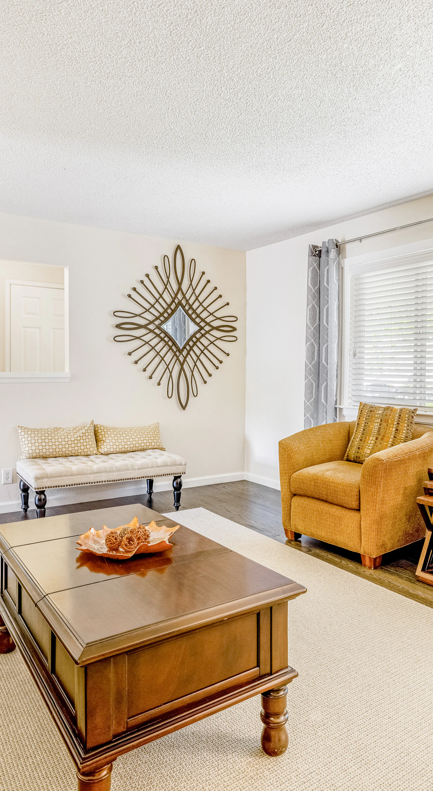 Gather your group in the sunlit sitting area — accent chairs and a picture window create the perfect spot to plan your Sonoma Valley vineyard itinerary.
