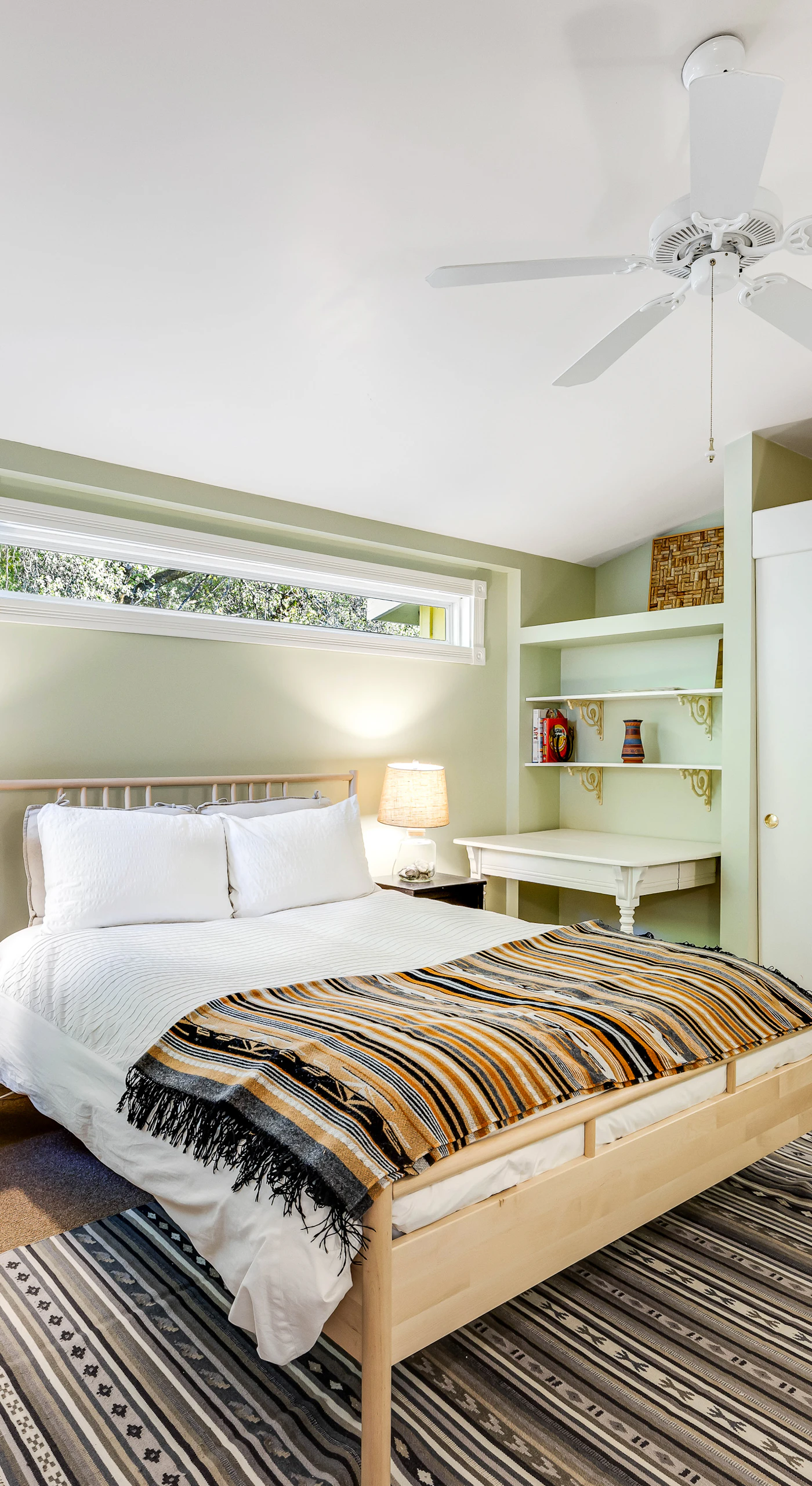 Drift off in your serene master bedroom with plush queen bed, built-in shelving, and a ceiling fan for year-round Cloverdale comfort