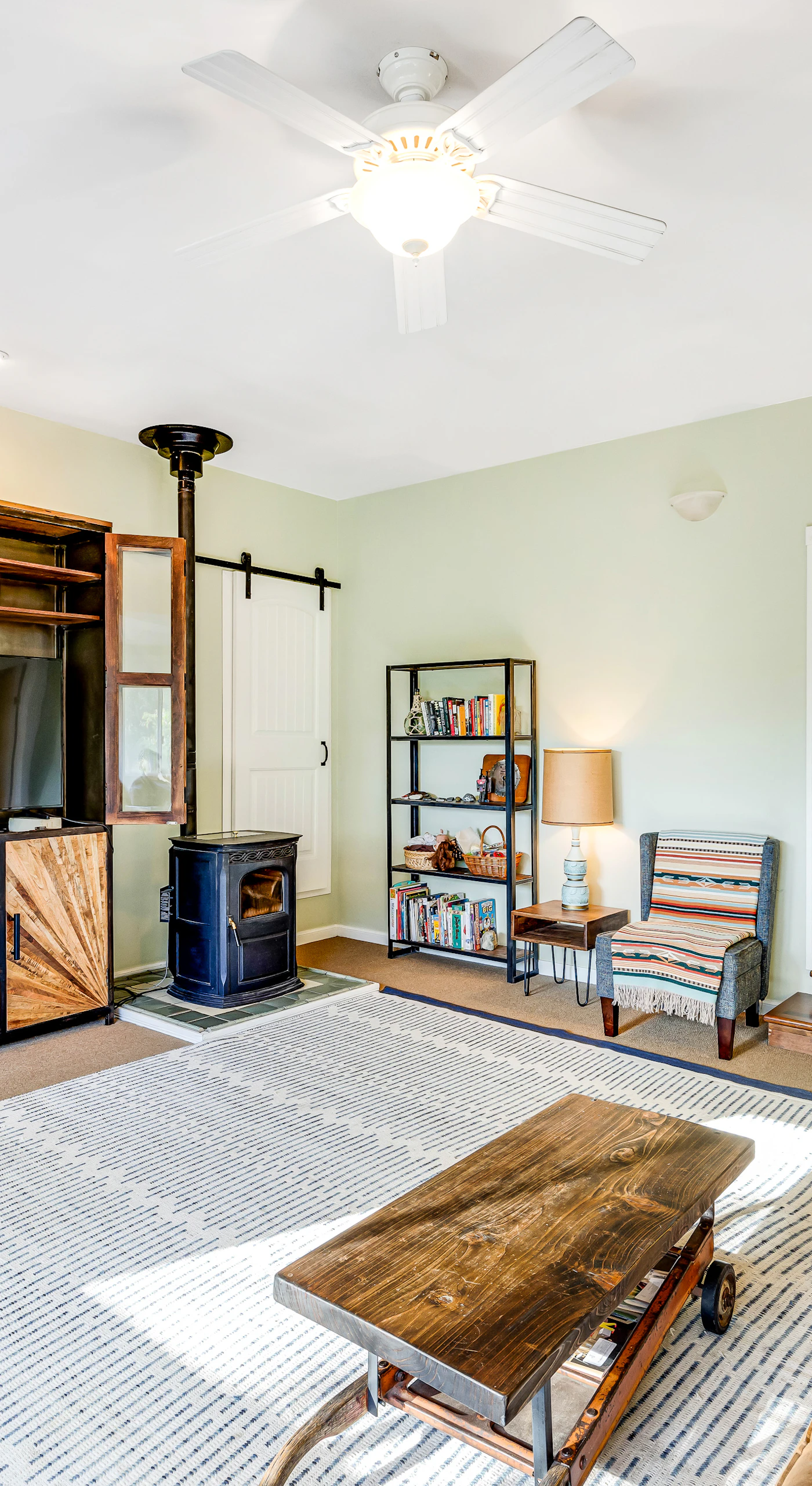 Settle into your sun-filled living room with rustic barn-door entertainment center, wood stove, and hardwood floors perfect after a day of wine tasting