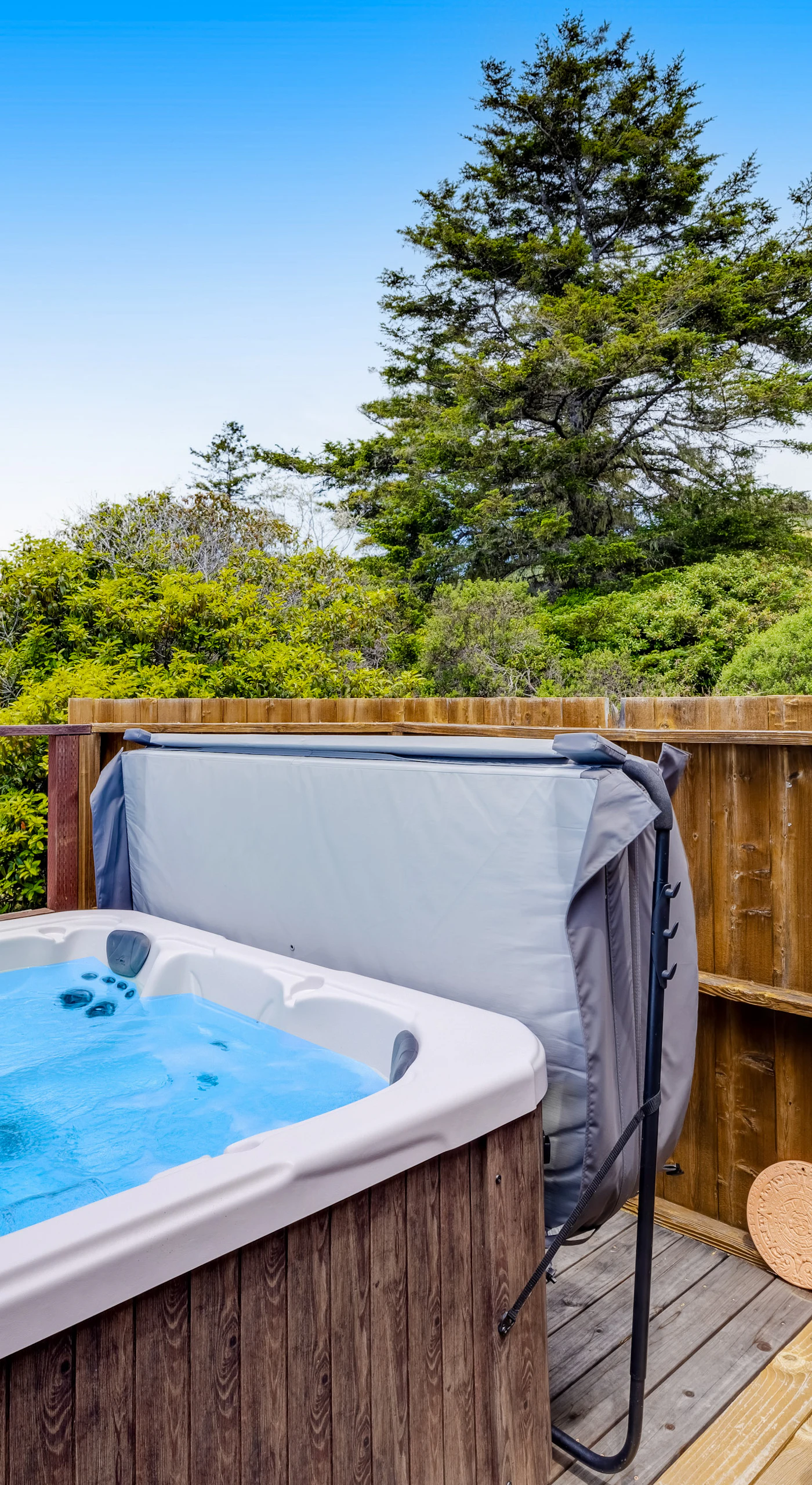 Let the bubbles of your hot tub massage away the day's adventures while you take in the serene coastal landscape.