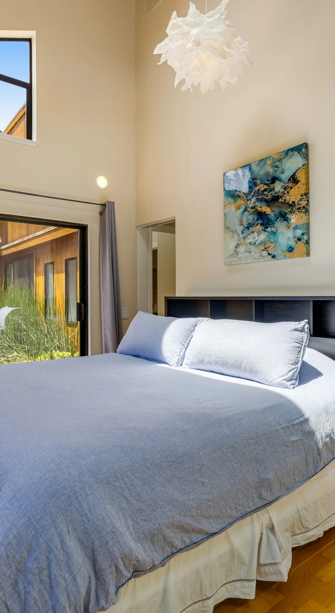 Awaken in the master bedroom, where large windows invite natural light and stunning views, creating a tranquil retreat for restful nights.